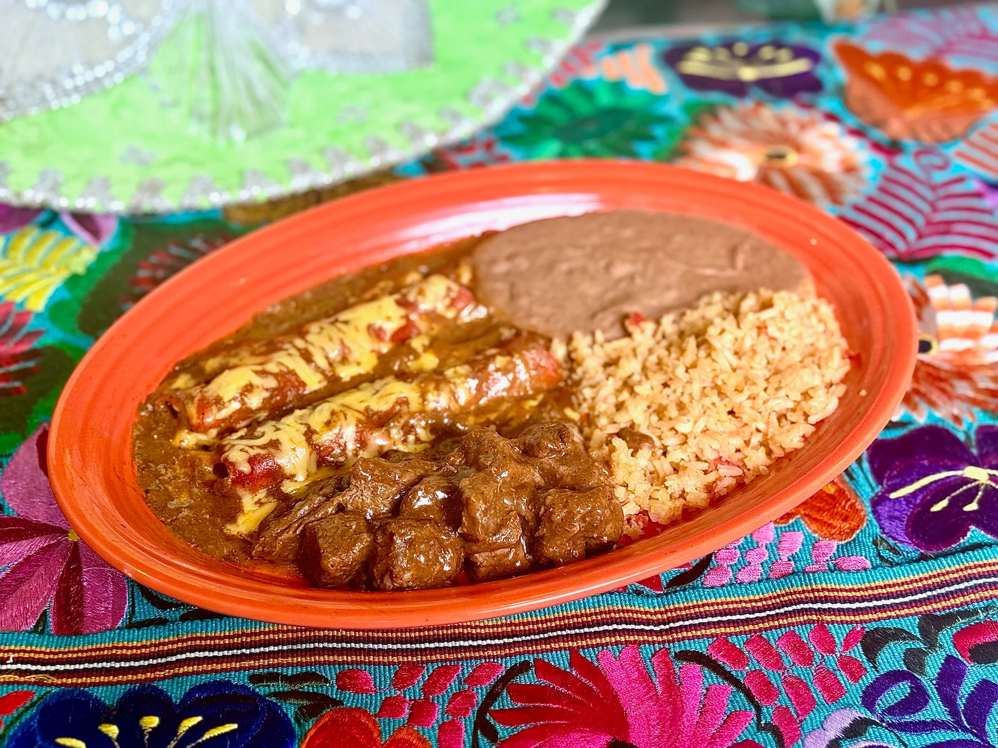 Plate of Mexican enchiladas with rice and beans