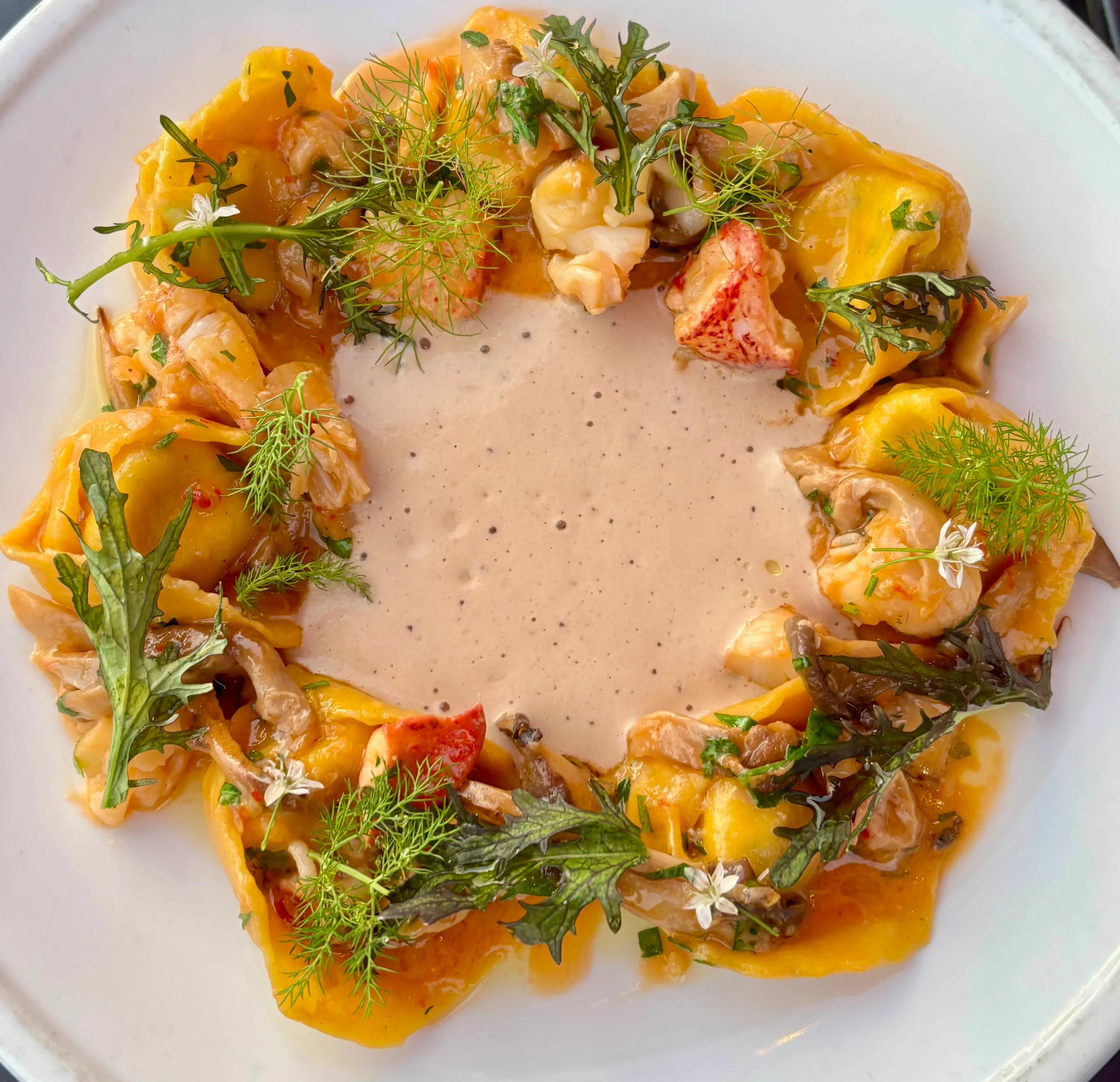 Lobster ravioli with creamy sauce in a fine dining setting