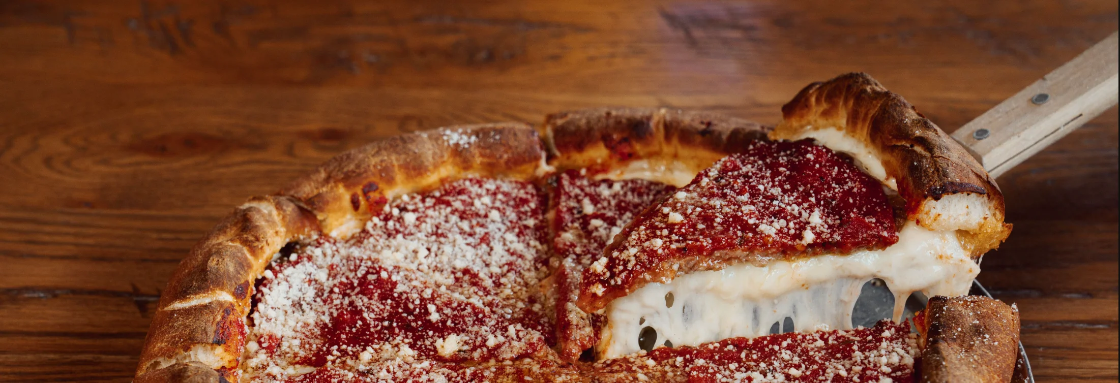 Deep-dish pizza with rich tomato sauce and melted cheese