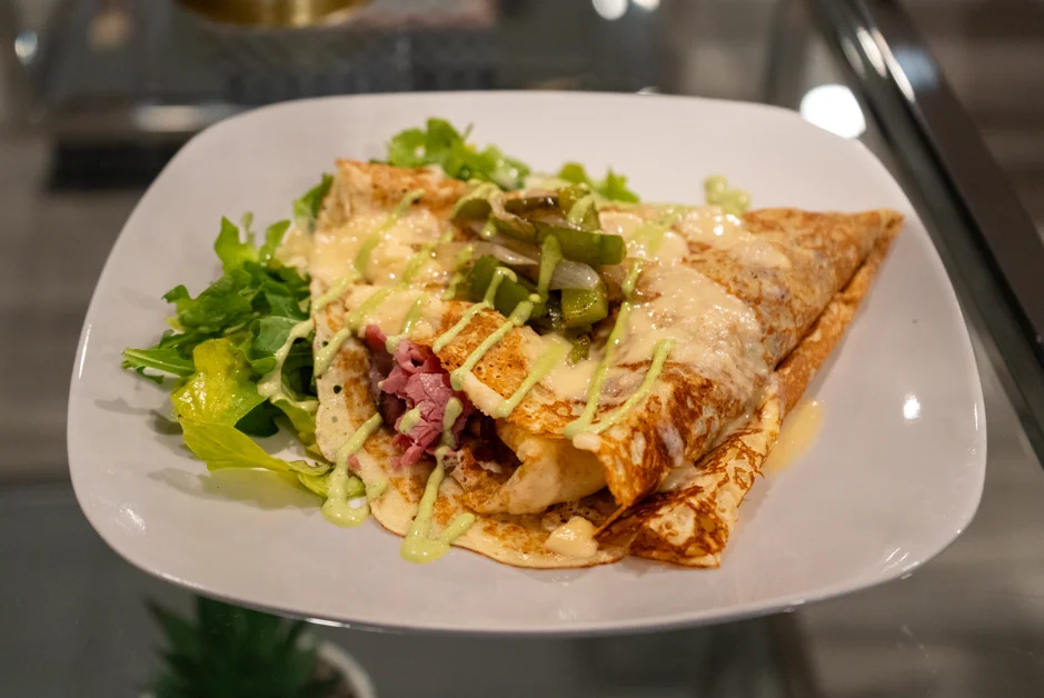 Delicious Mexican enchiladas topped with cheese and green sauce