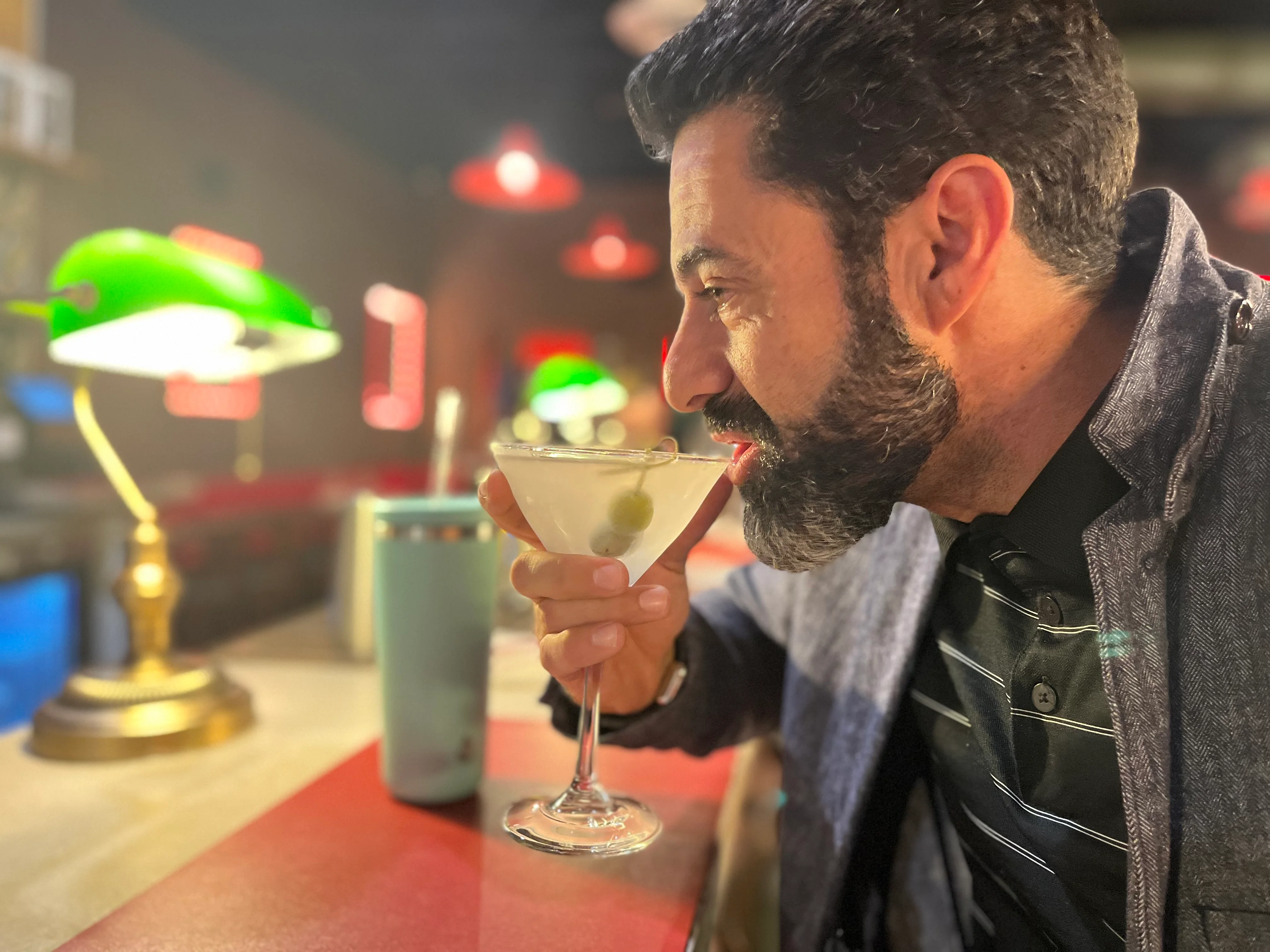 Man enjoying a classic martini at a stylish bar