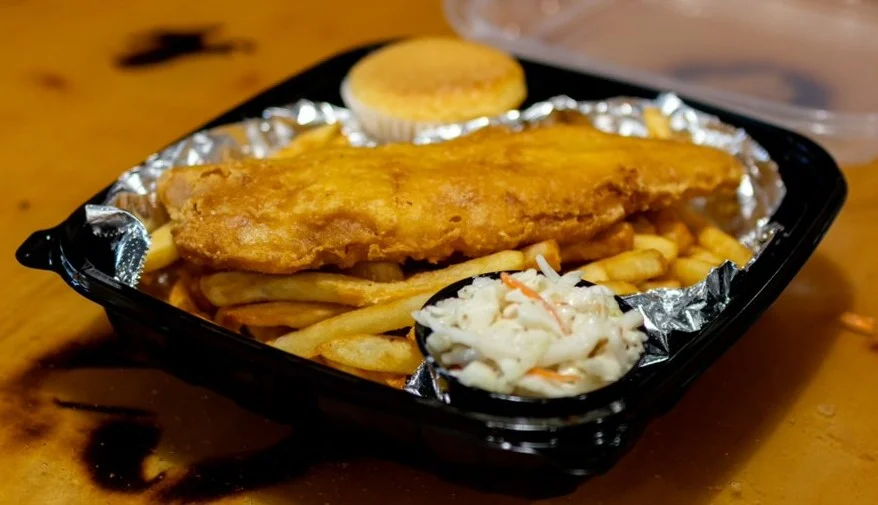 Classic American fish and chips with coleslaw and cornbread