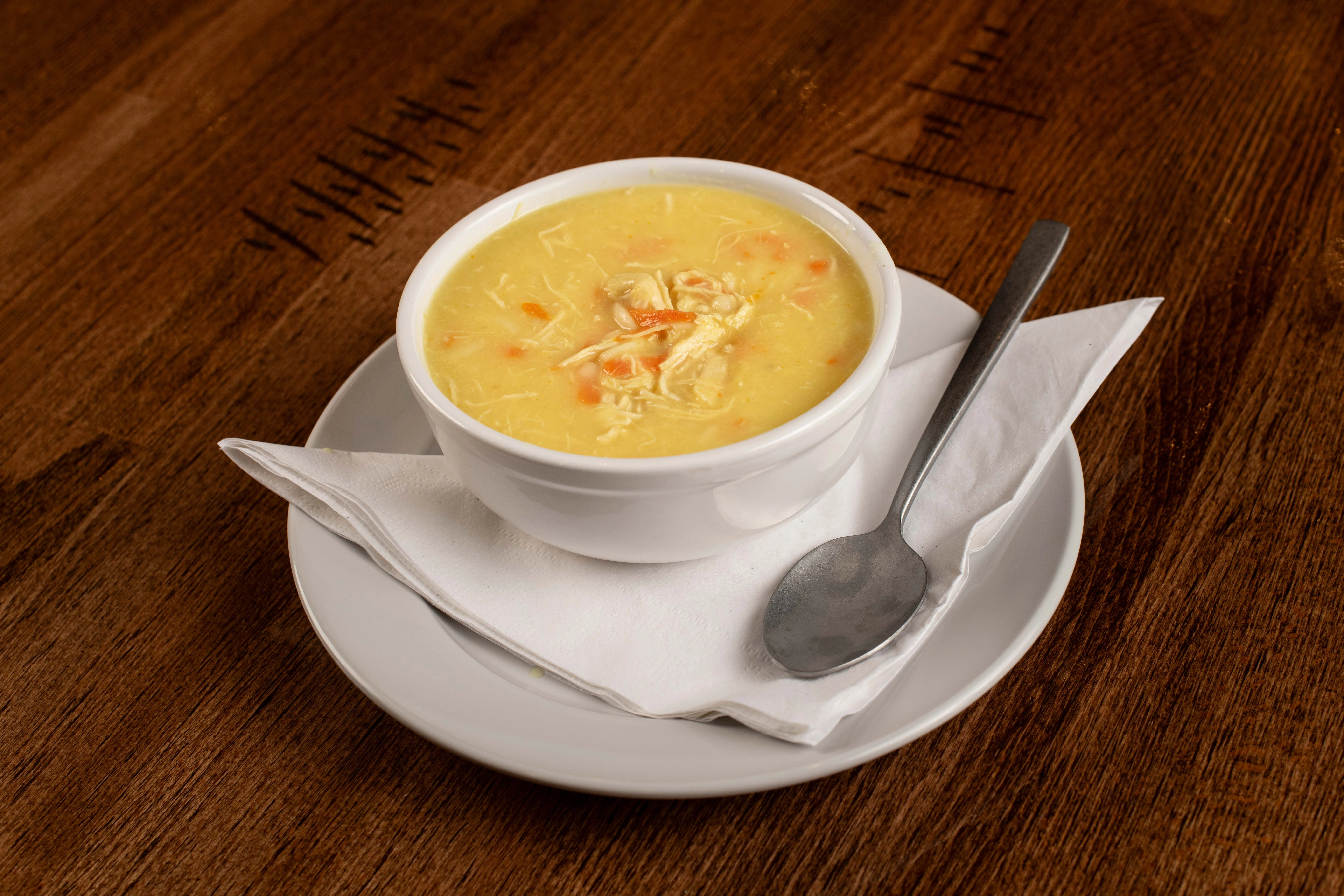 Creamy chicken soup in a white bowl