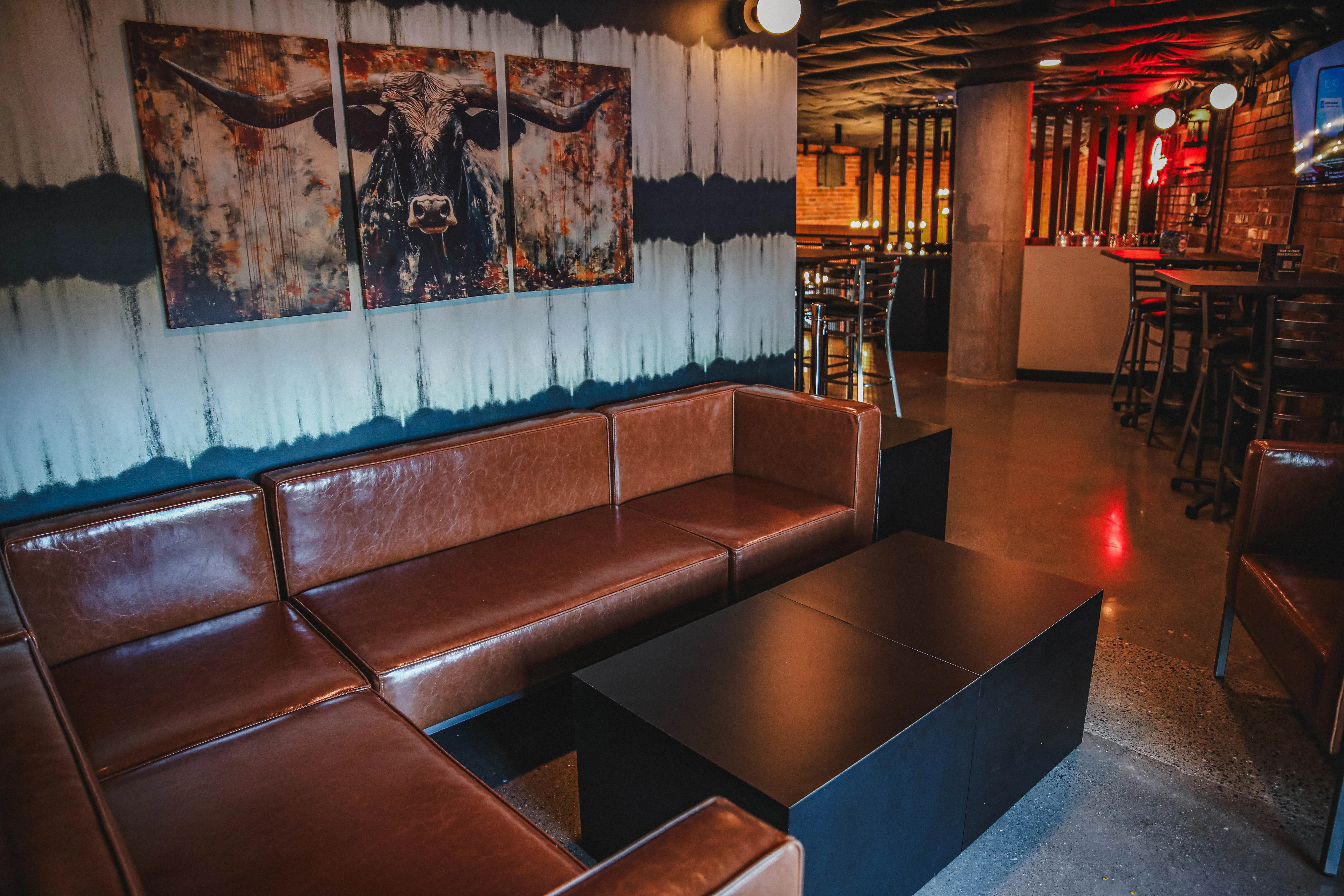 Stylish restaurant interior with leather seating and artistic wall decor