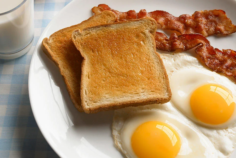 Classic American breakfast with eggs, bacon, and toast