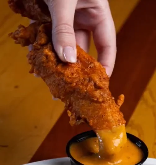 Crispy fried chicken tender with cheese dip