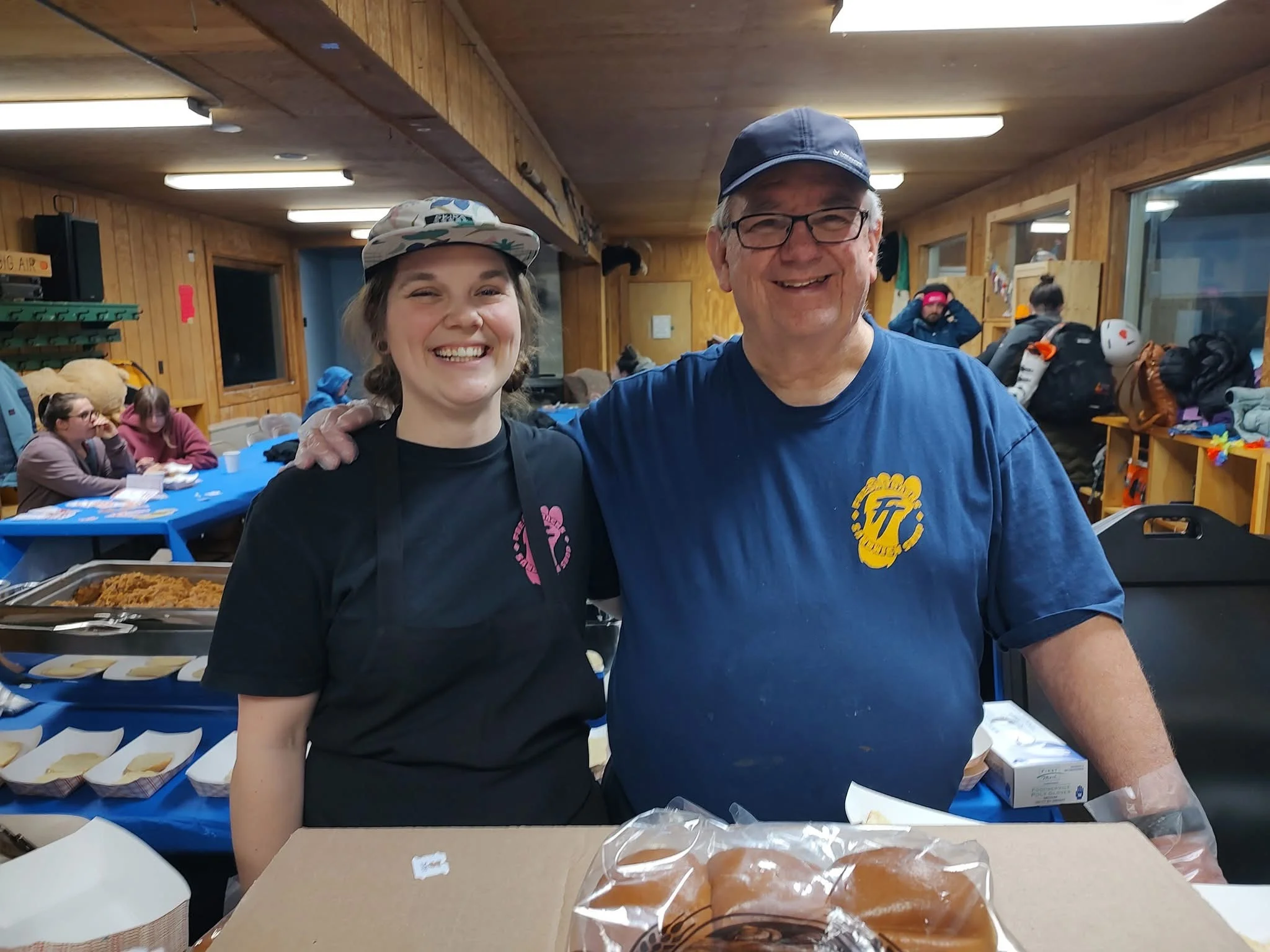 Friendly staff serving food in a cozy dining area