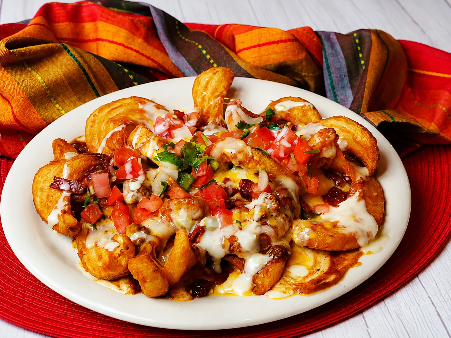 Loaded nachos topped with cheese and fresh salsa