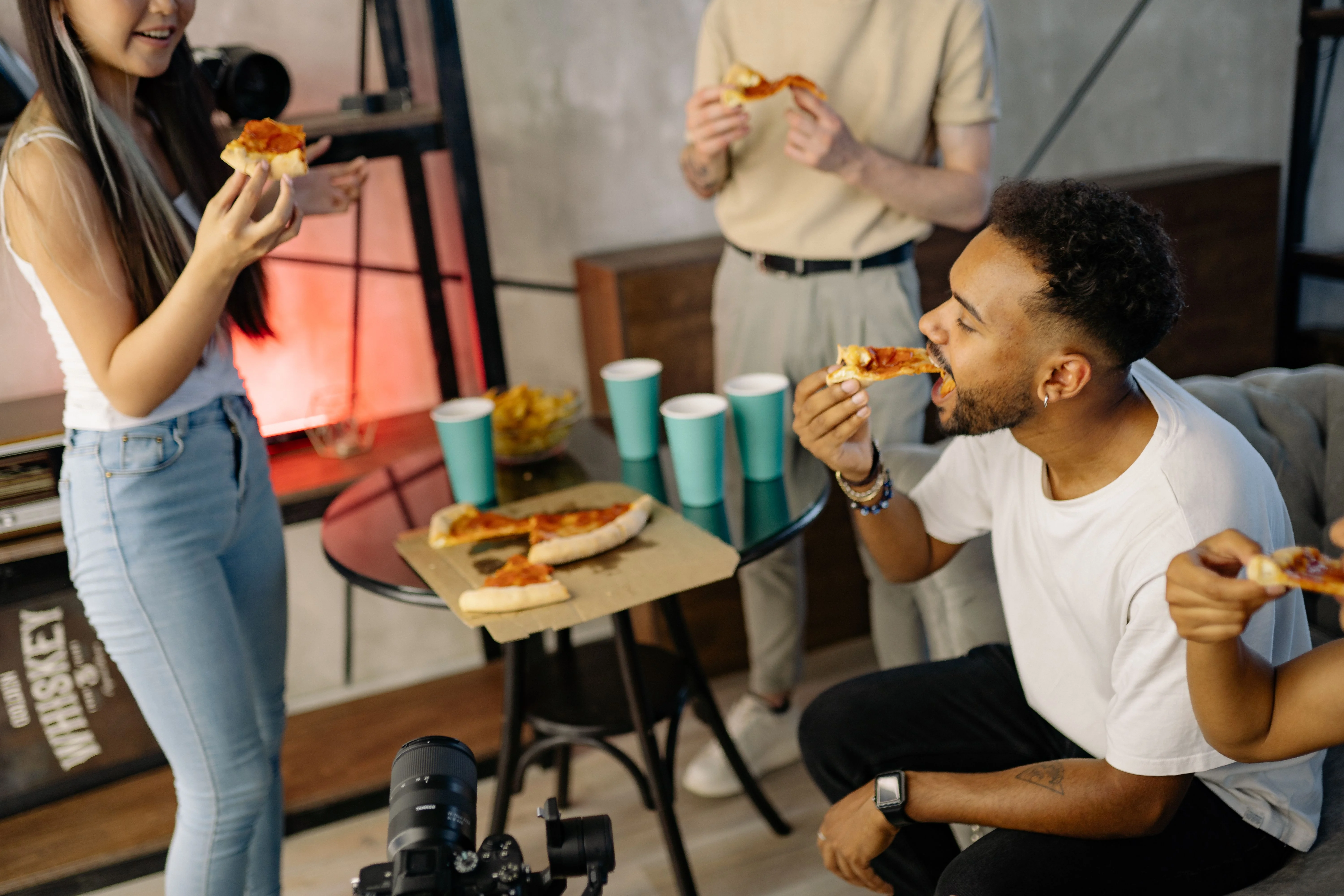 Friends sharing pizza at a restaurant table