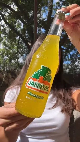 Bottle of Jarritos pineapple soda in sunlight