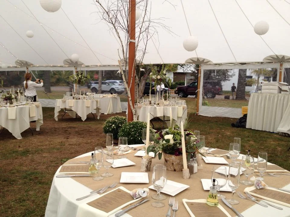 Elegant outdoor dining setup under a tent for a special event