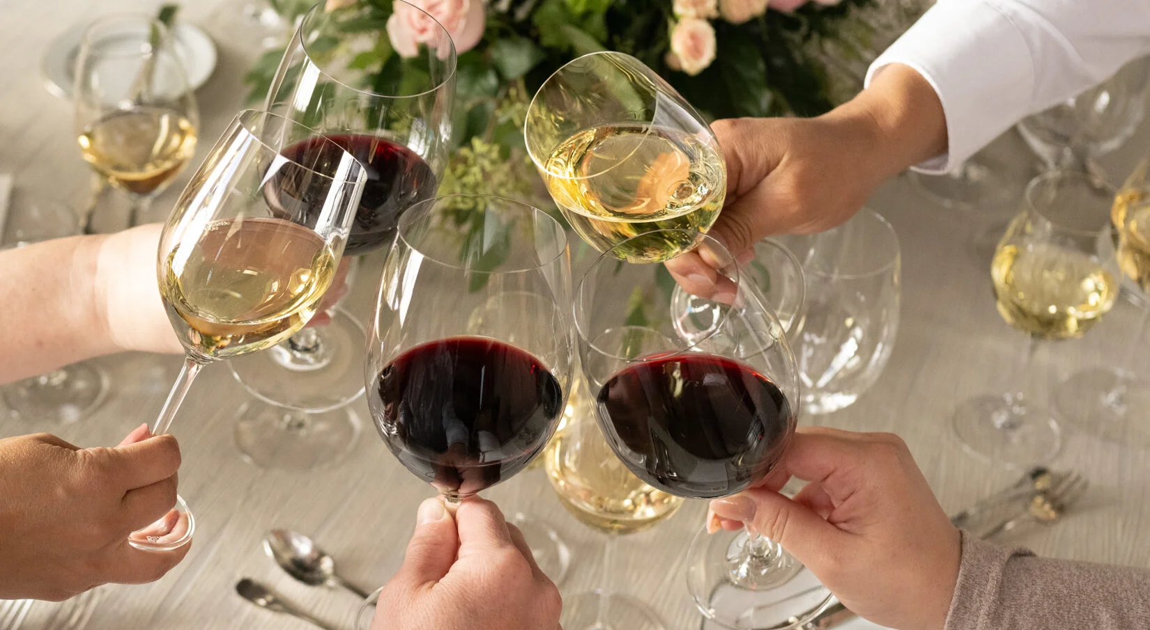 Cheers with red and white wine glasses at a festive gathering