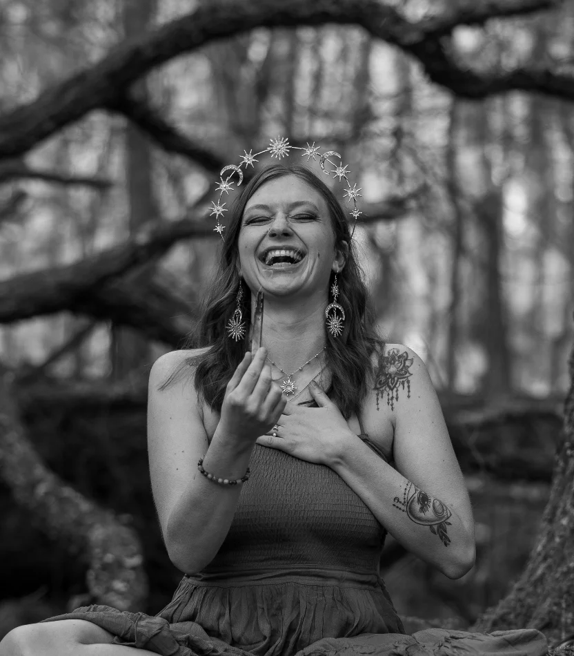 Smiling woman with flower crown at a candlelit table