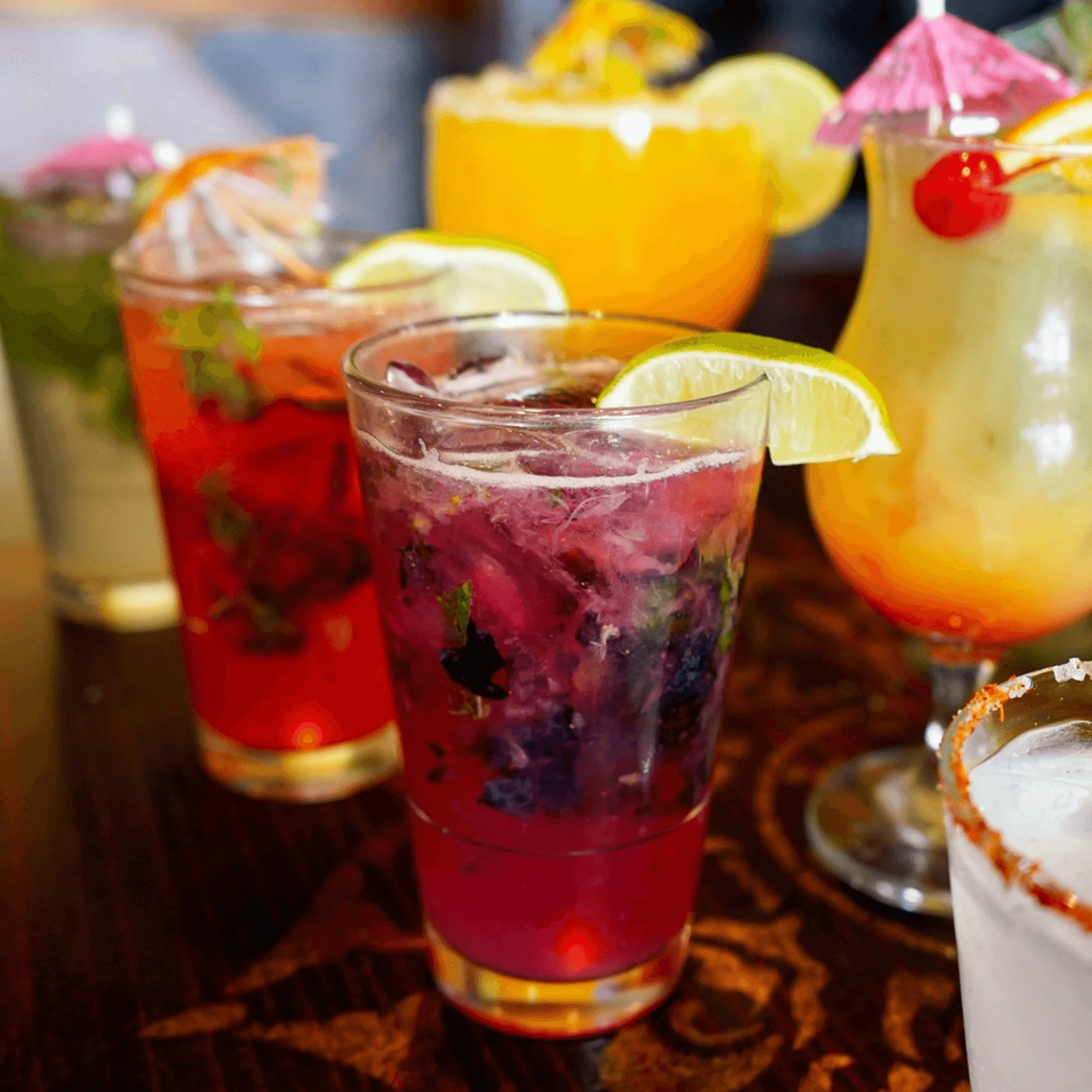 Colorful cocktails with garnishes at a vibrant bar