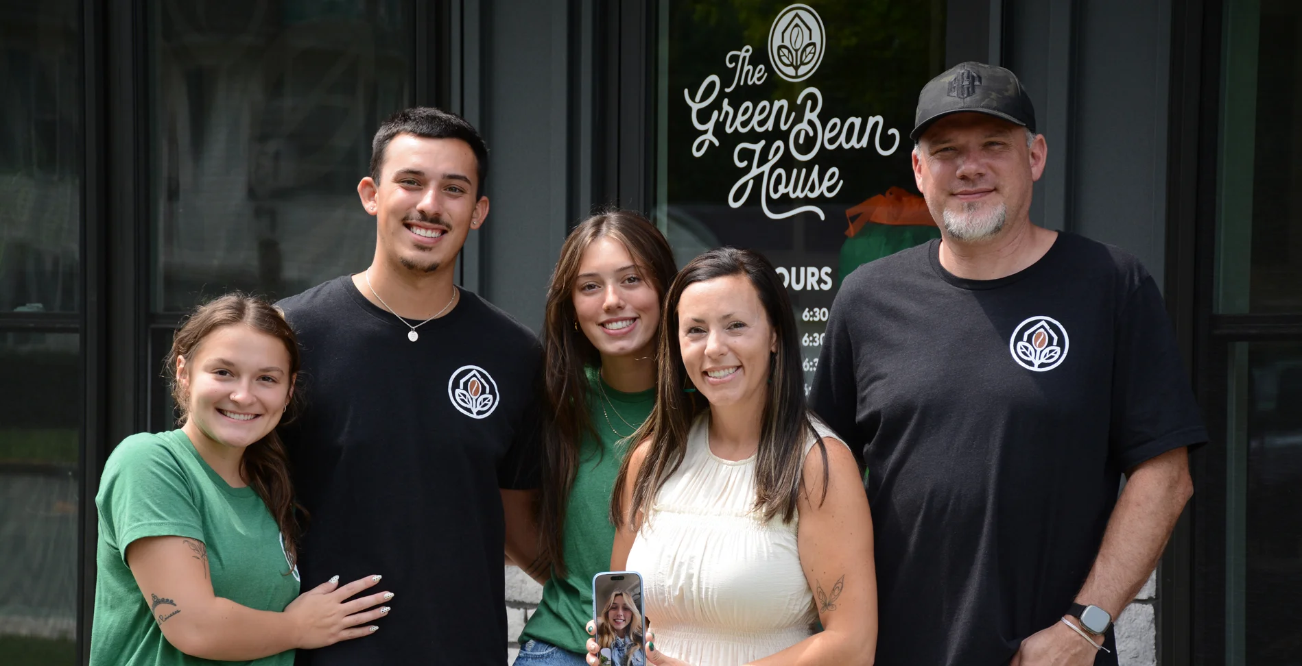 Family posing outside The Green Bean House restaurant