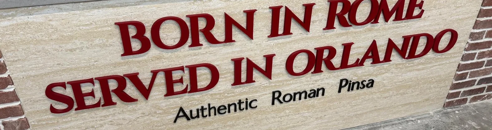 Entrance counter at Daje Pinsa Roman Pizza displaying “Born in Rome, Served in Orlando” and “Authentic Roman Pinsa.”