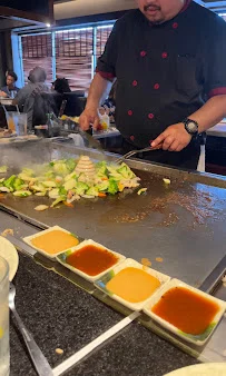 Teppanyaki chef preparing vegetables at a Japanese grill