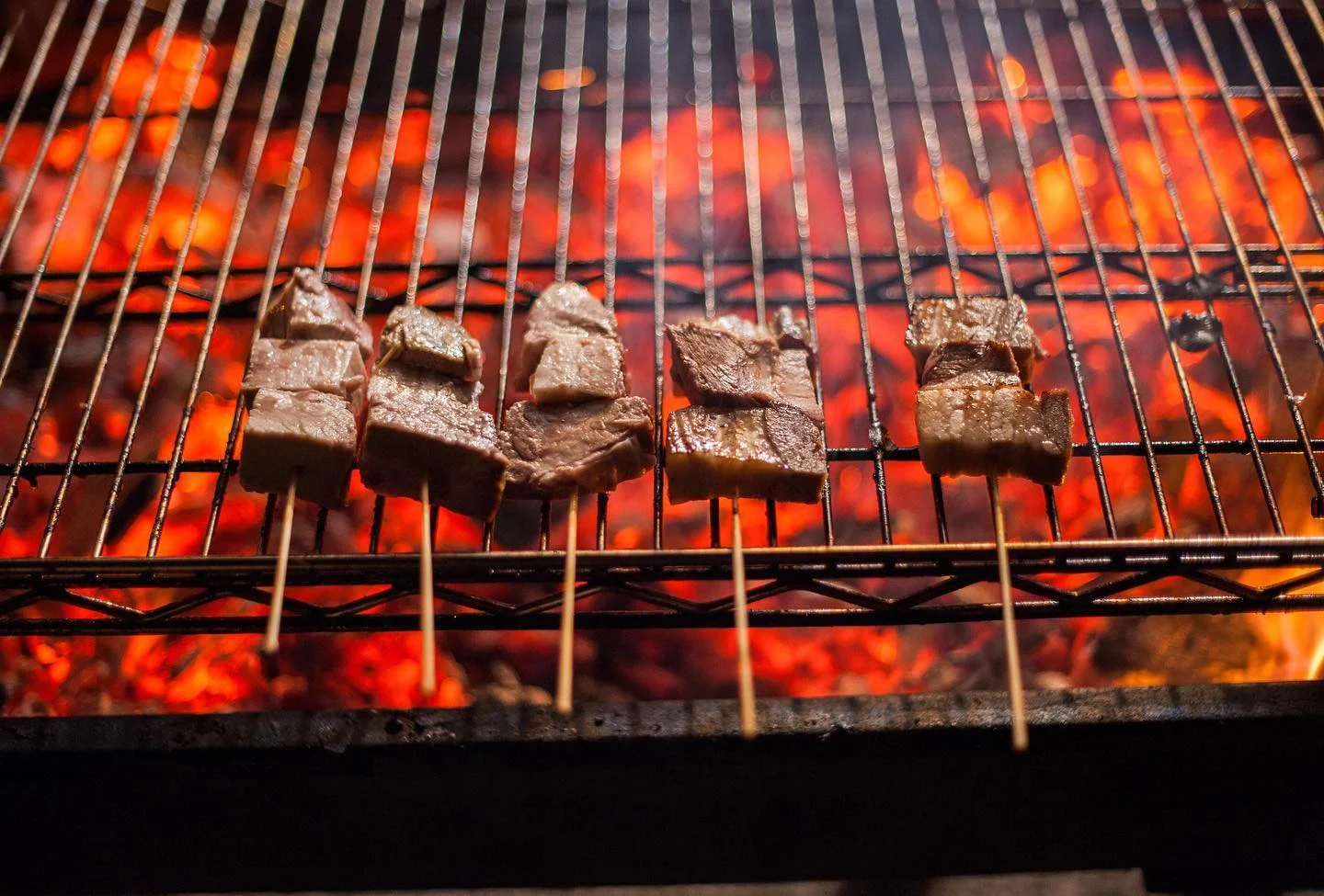 Grilled skewers of Brazilian churrasco over hot coals