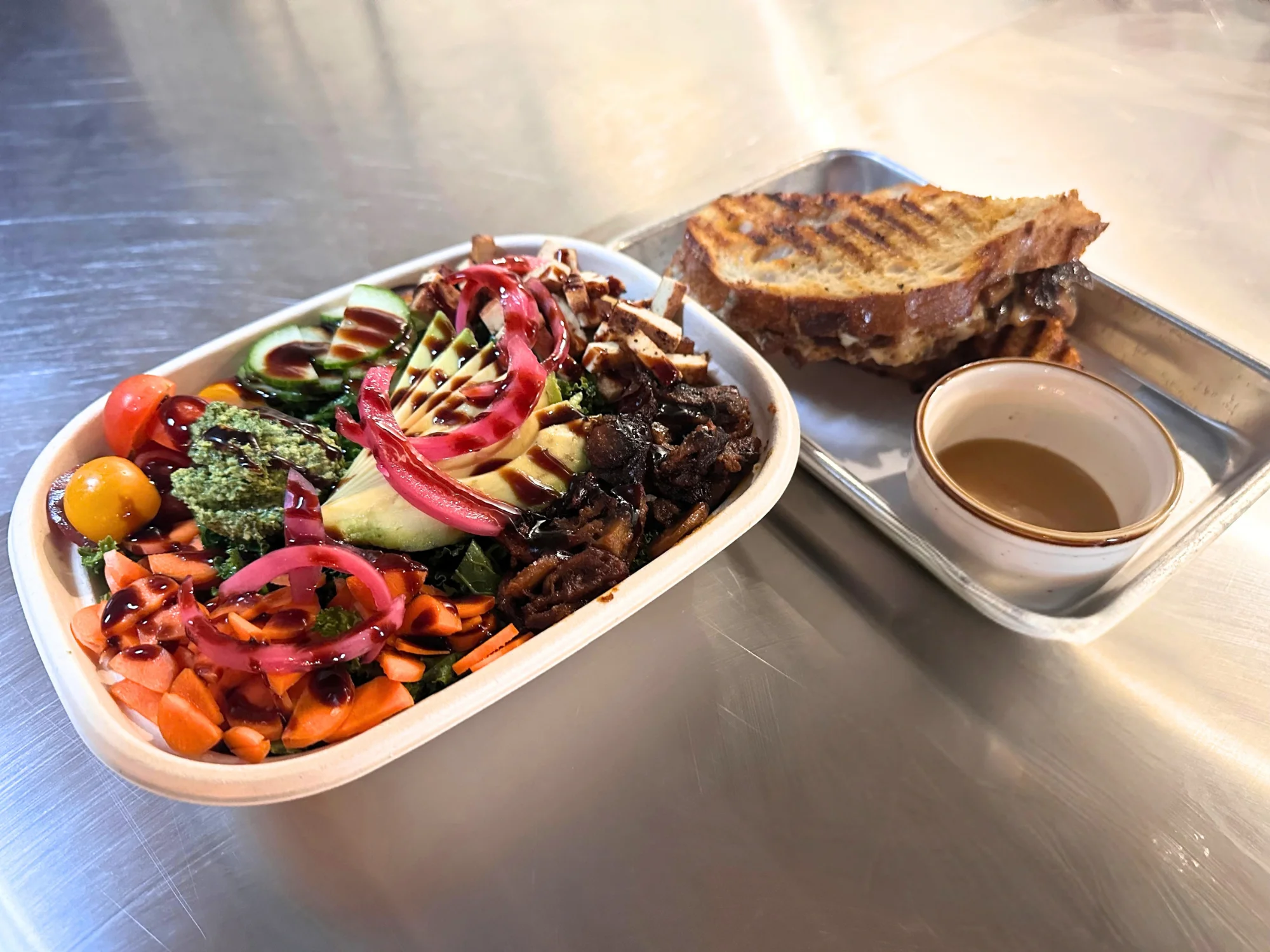 Fresh salad bowl with grilled sandwich and dipping sauce