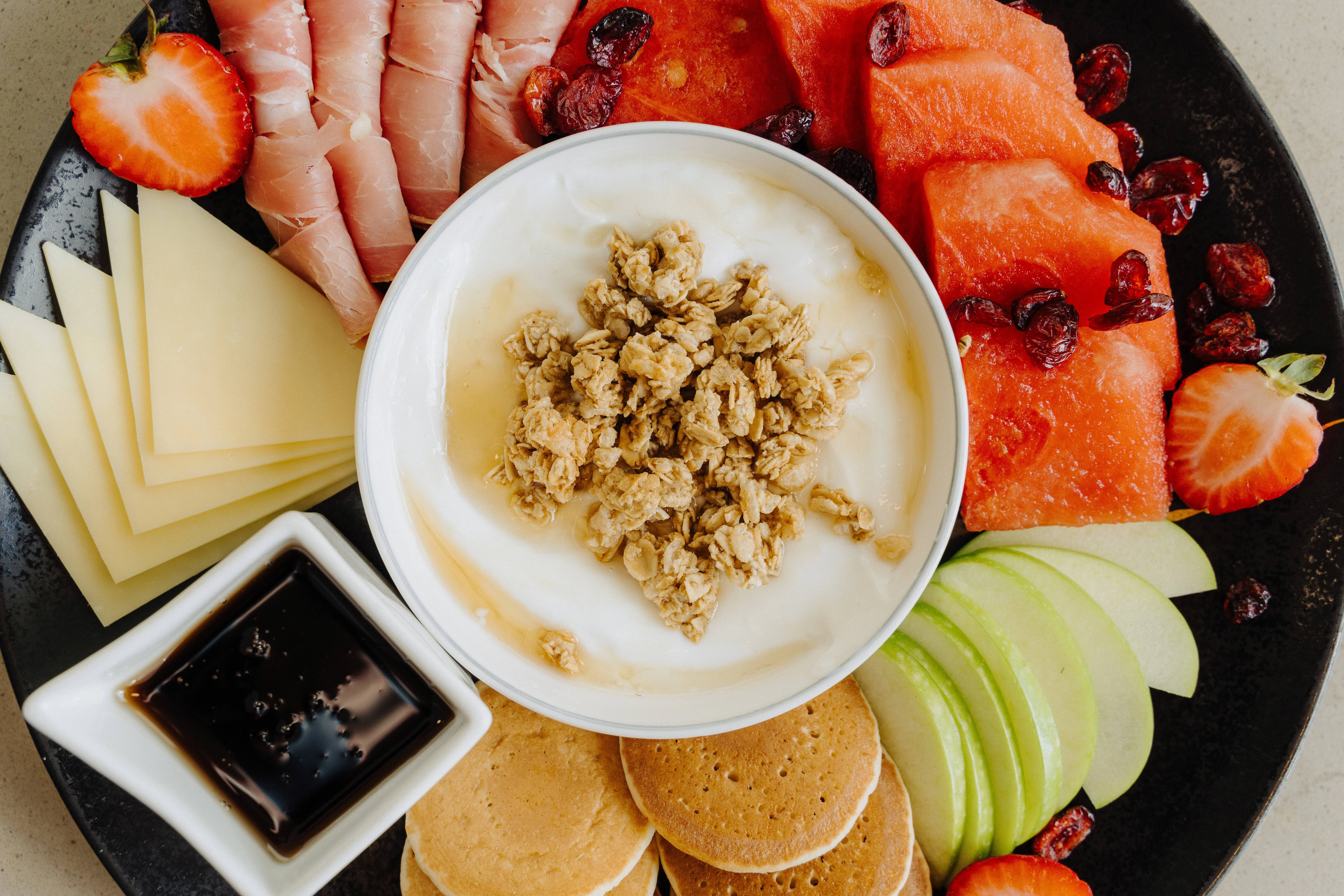 Assorted breakfast platter with yogurt and fresh fruits