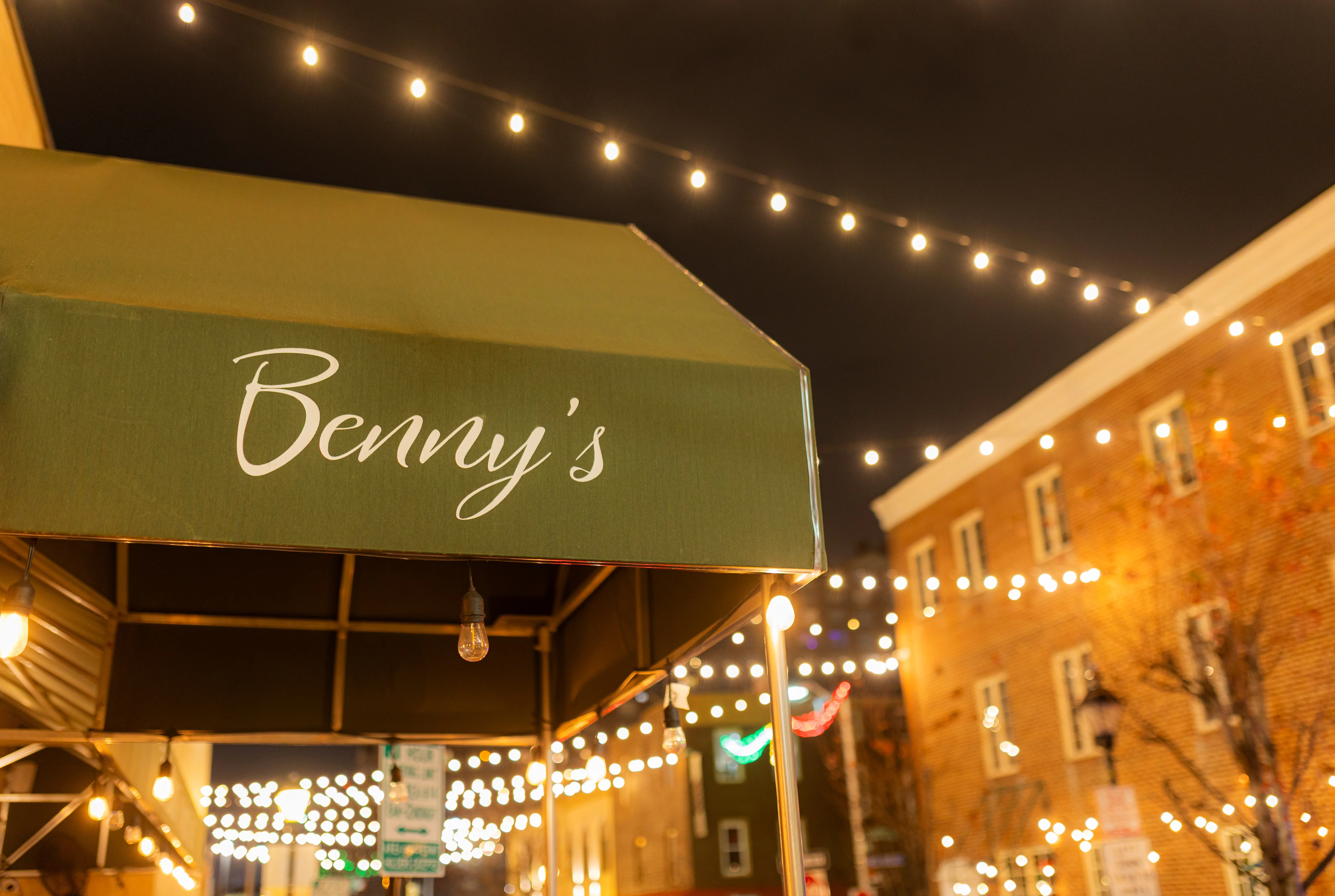 Cozy restaurant awning with string lights at night