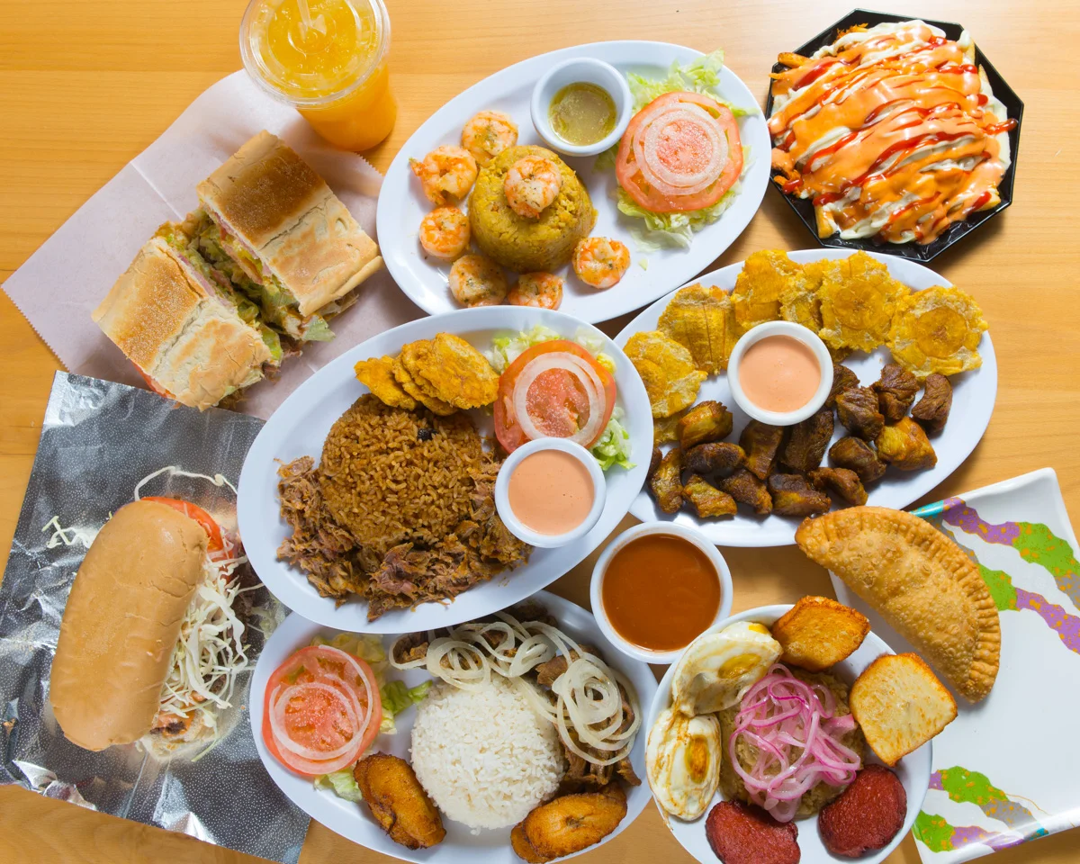 Assorted Latin American dishes including rice, plantains, and empanadas