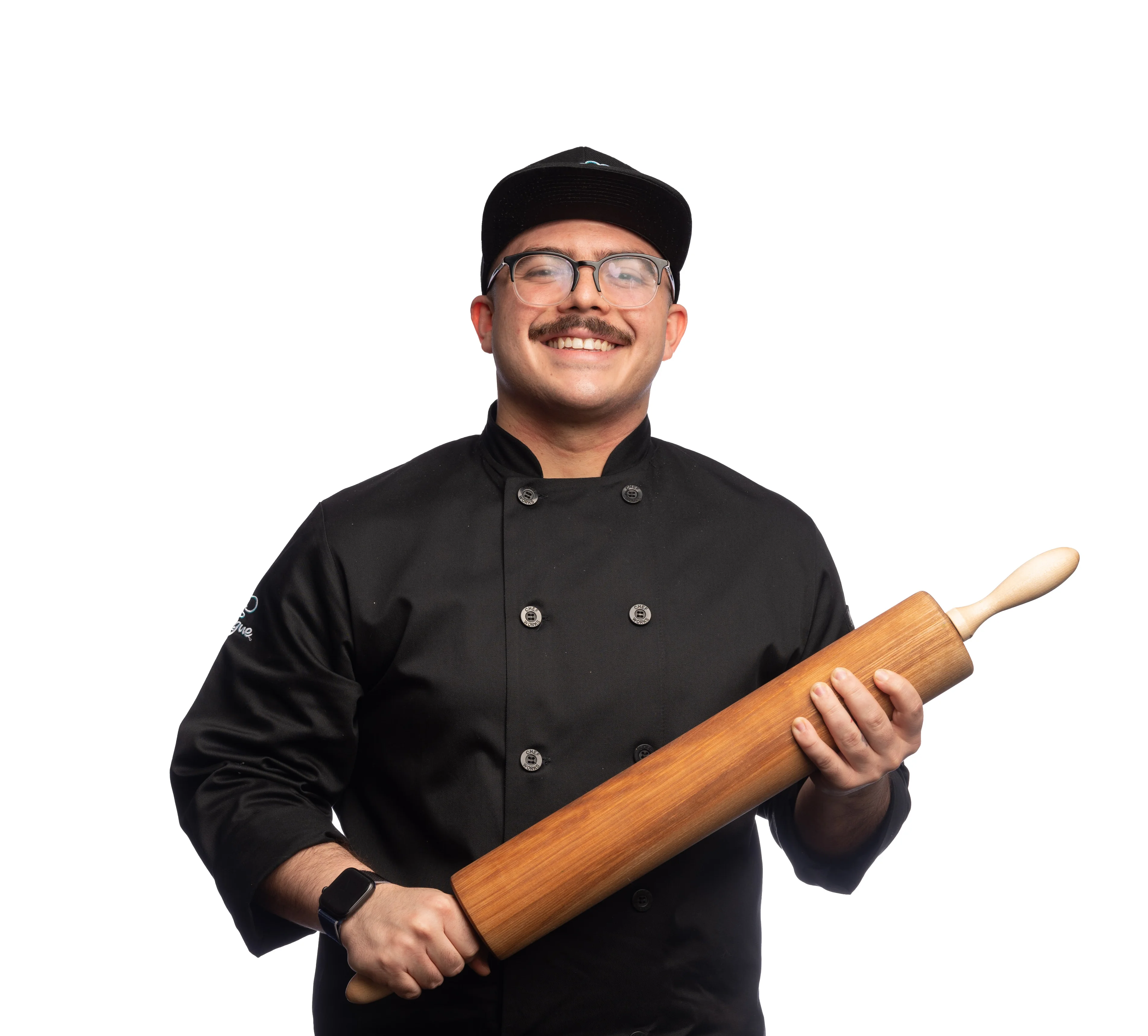 Chef holding a rolling pin in a professional kitchen setting