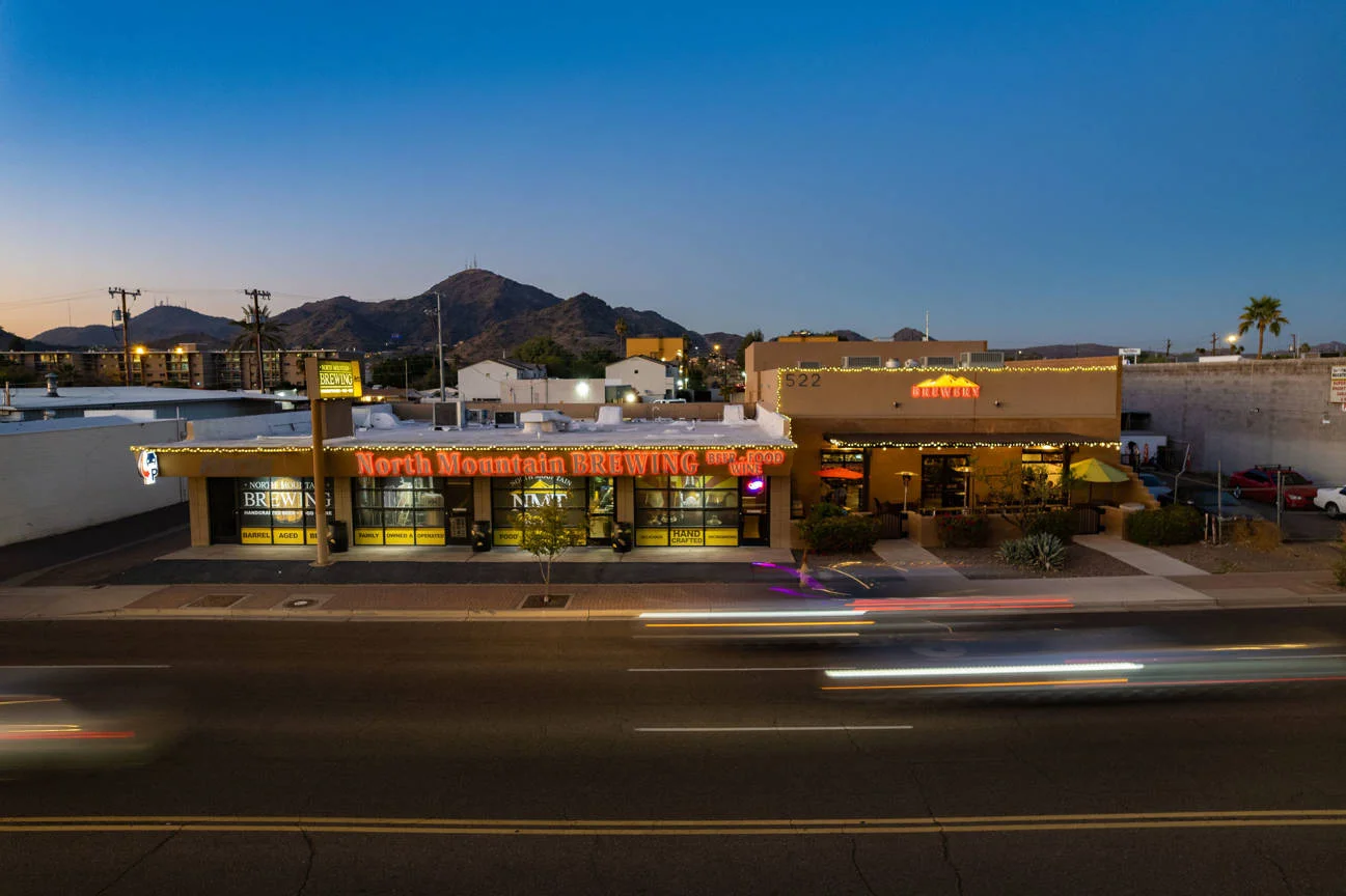 North Mountain Brewing restaurant exterior at dusk with mountain backdrop