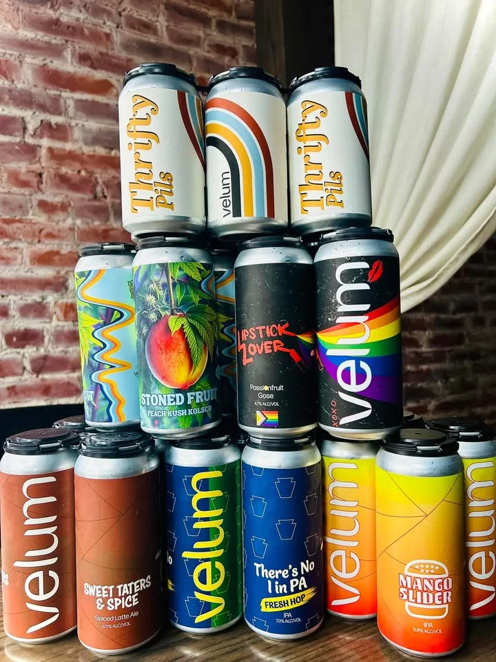 A collection of colorful beverage cans stacked together, showcasing various flavors and designs.
