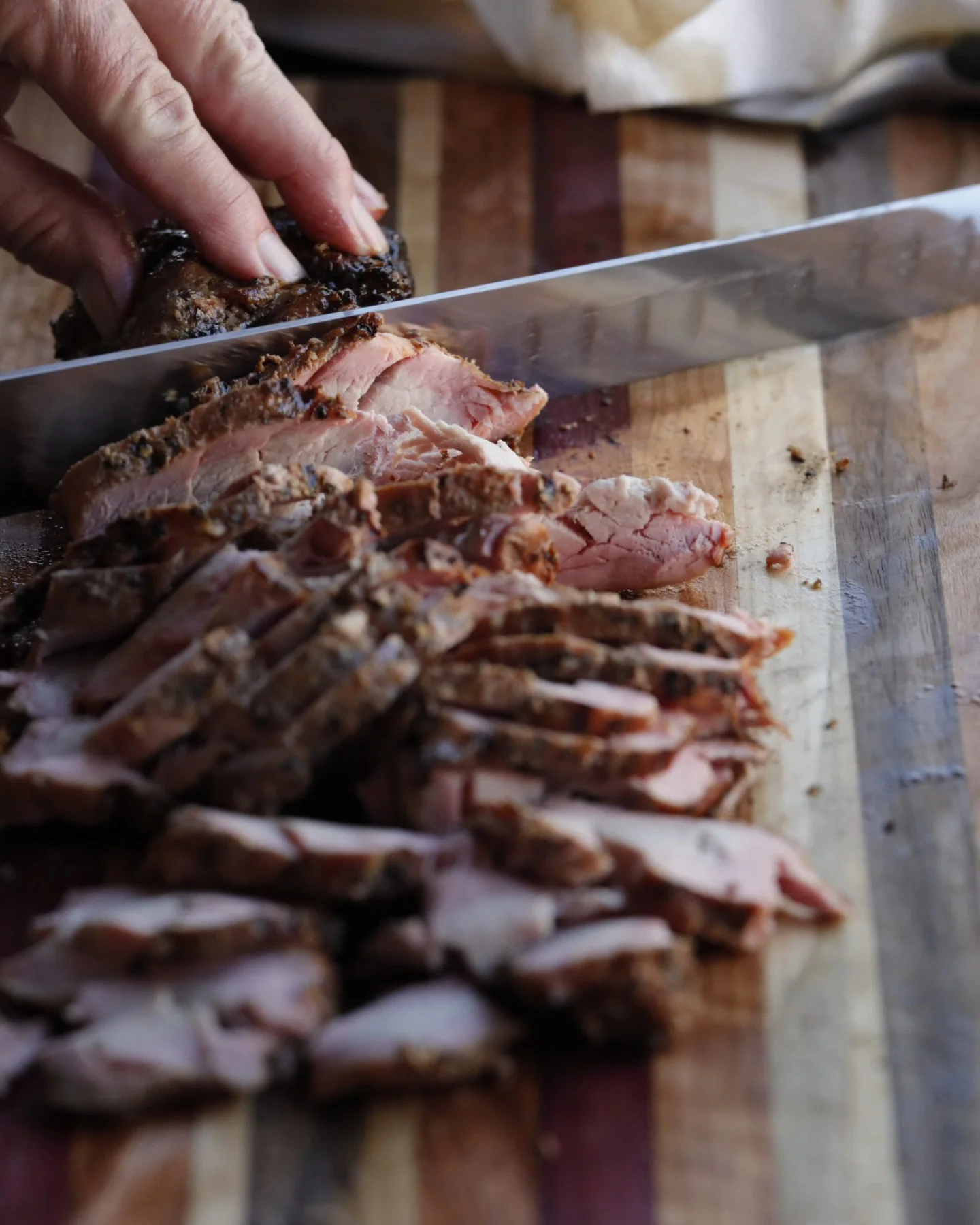 Sliced smoked brisket on a wooden cutting board