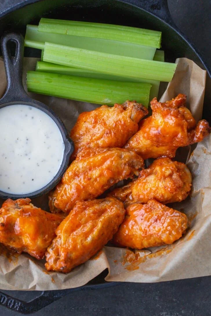 Crispy buffalo chicken wings with celery and ranch dressing