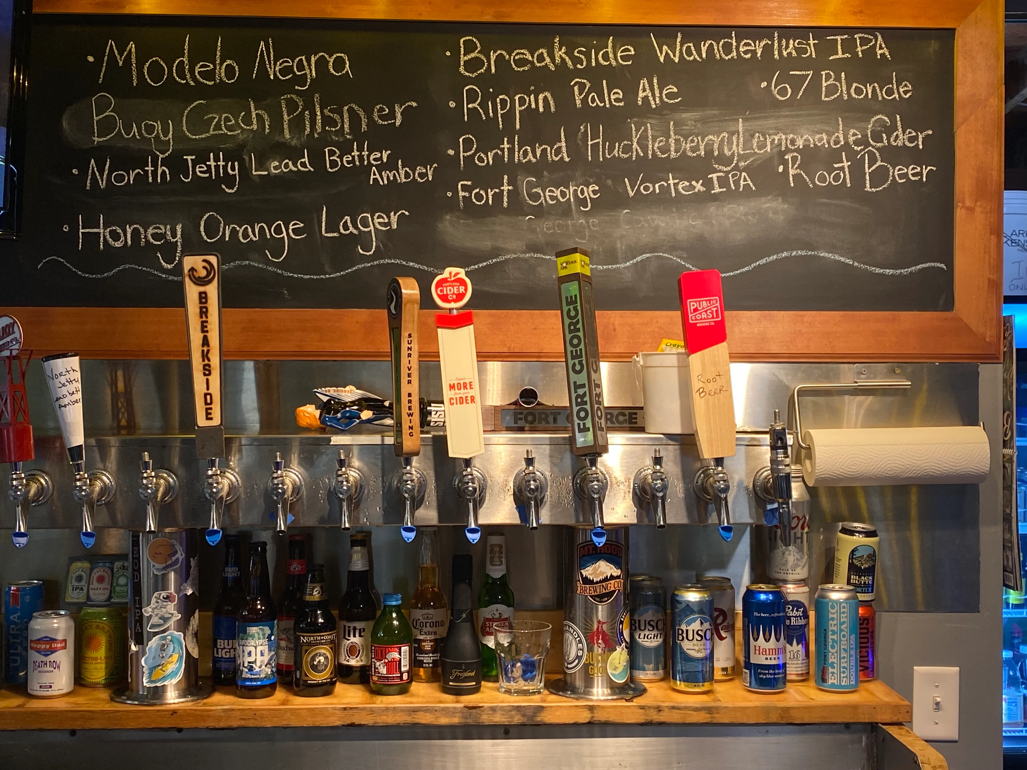 Craft beer selection at a vibrant bar with various taps and bottles
