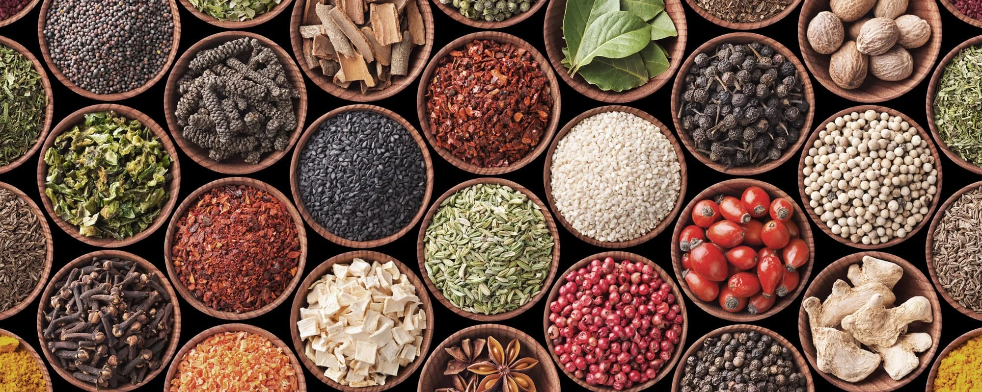 Variety of spices in wooden bowls for culinary use