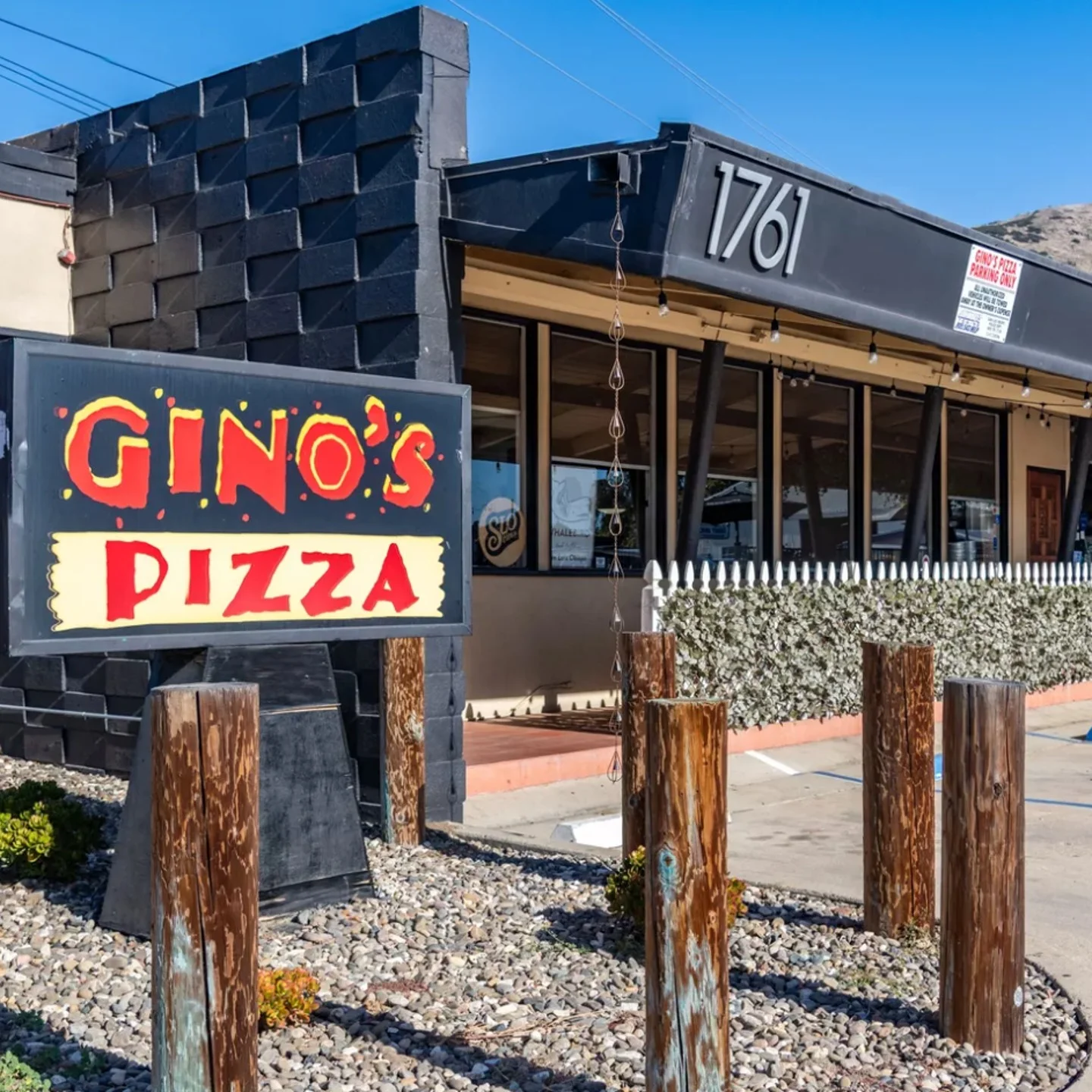 Exterior view of Gino's Pizza restaurant with vibrant signage