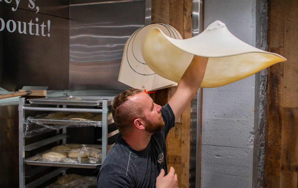 tossing pizza dough in the air