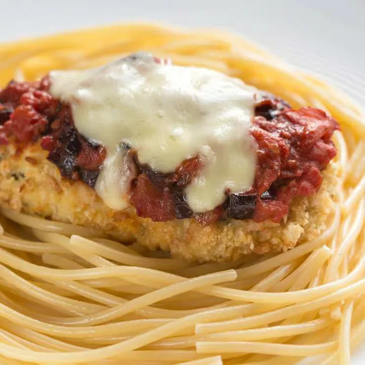 Italian chicken parmesan served over spaghetti