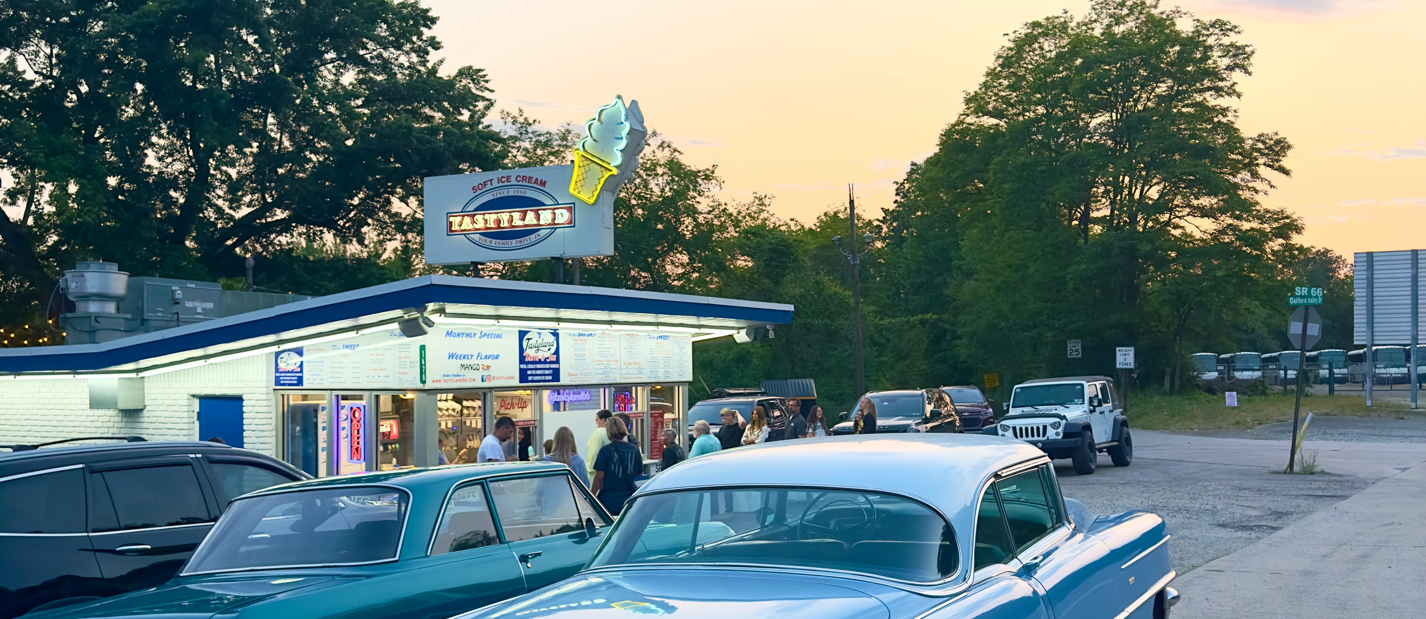 Tastyland 66 with a bustling crowd at sunset 