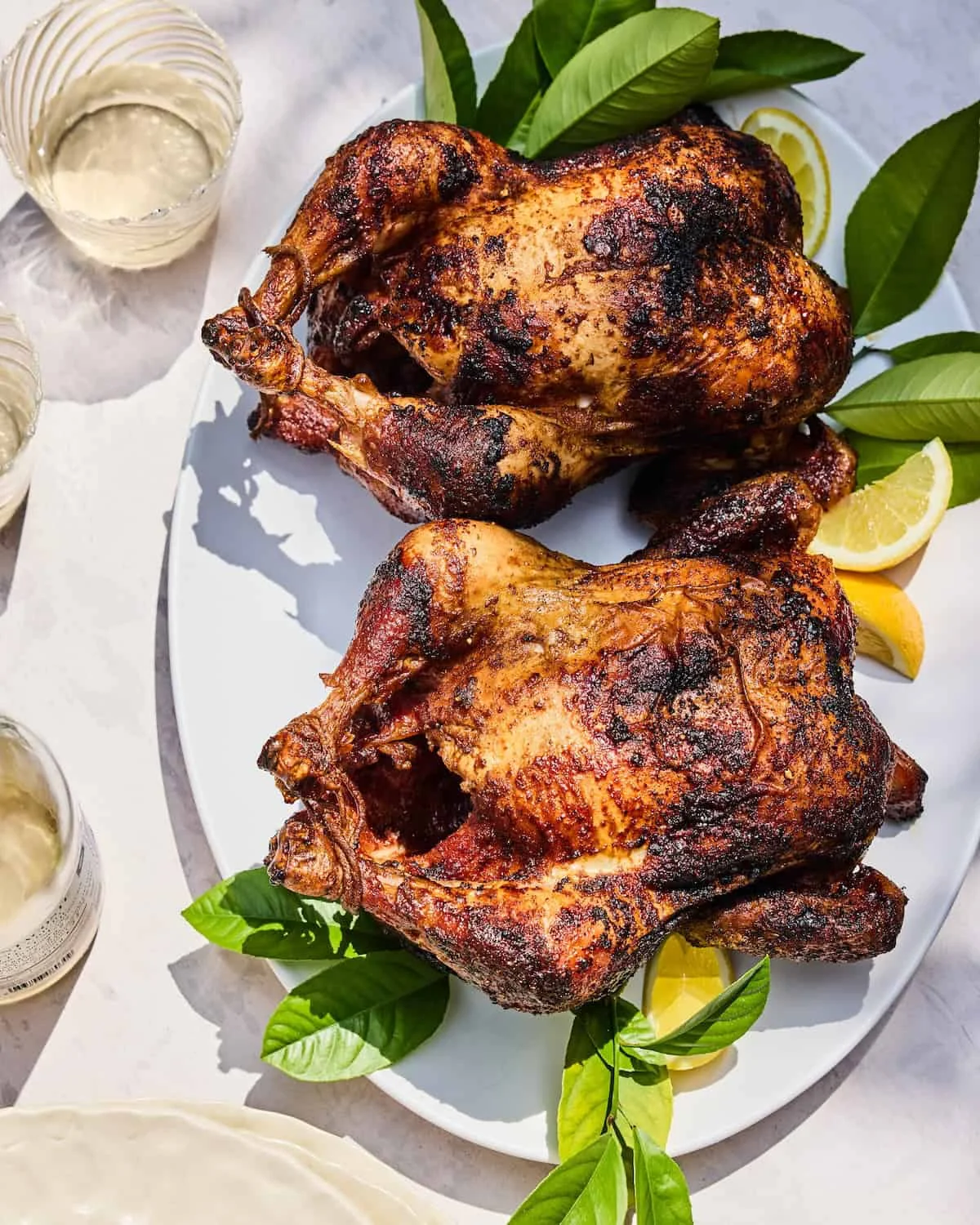 Crispy roasted Peruvian pollo a la brasa on a serving platter