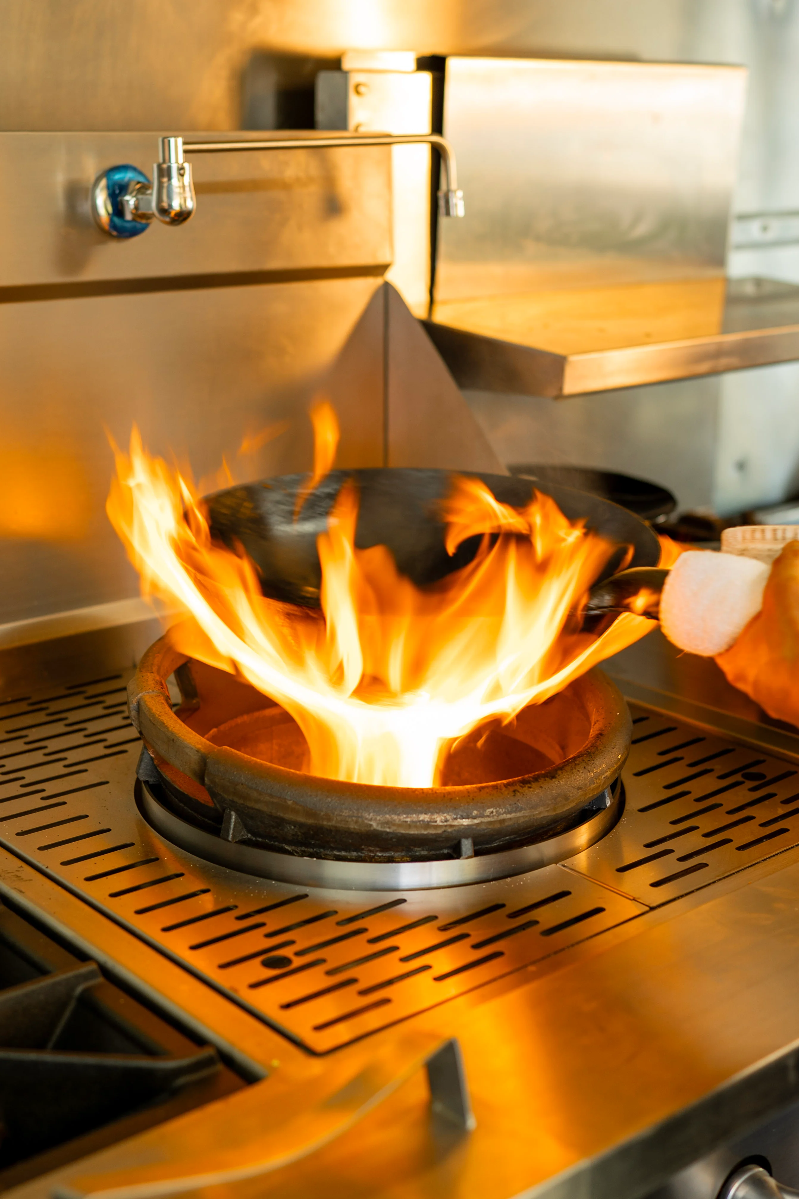 Flaming wok cooking in a professional kitchen