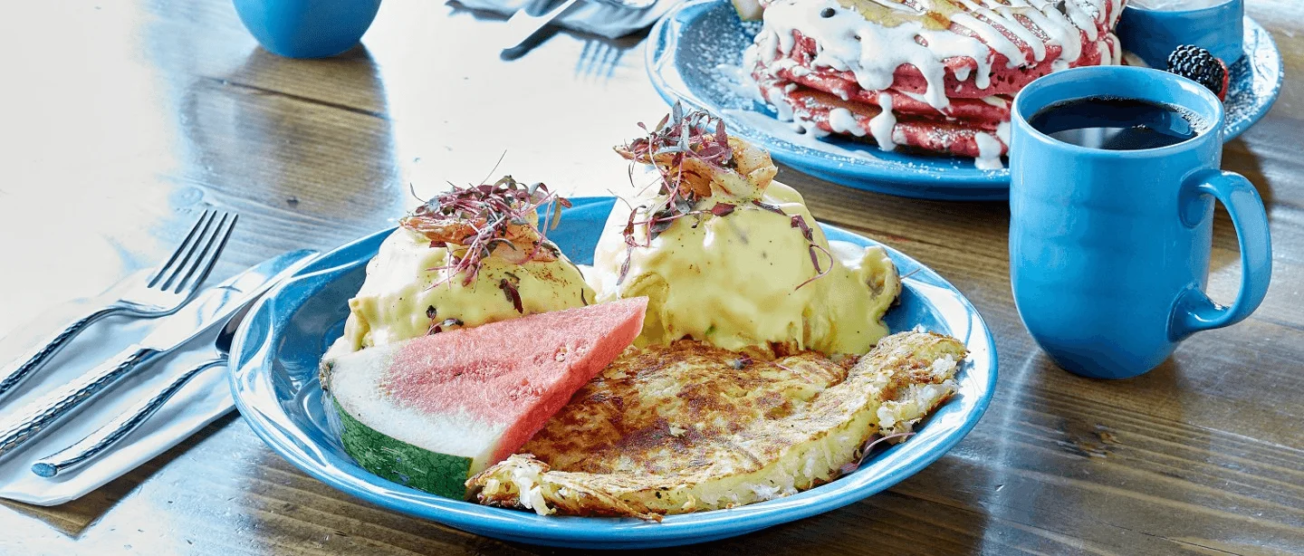 Classic Eggs Benedict with a side of watermelon