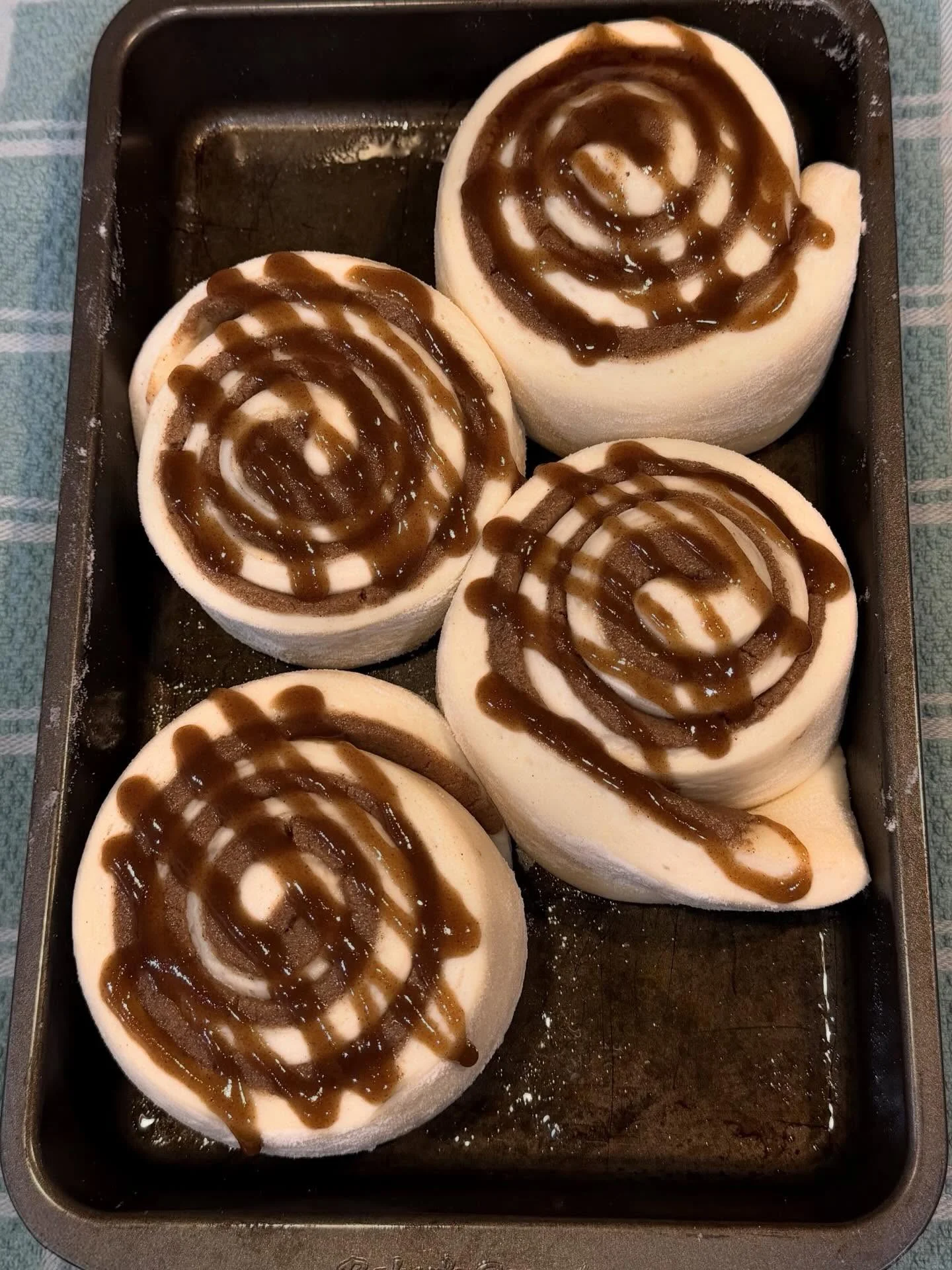 Freshly baked cinnamon rolls with caramel drizzle