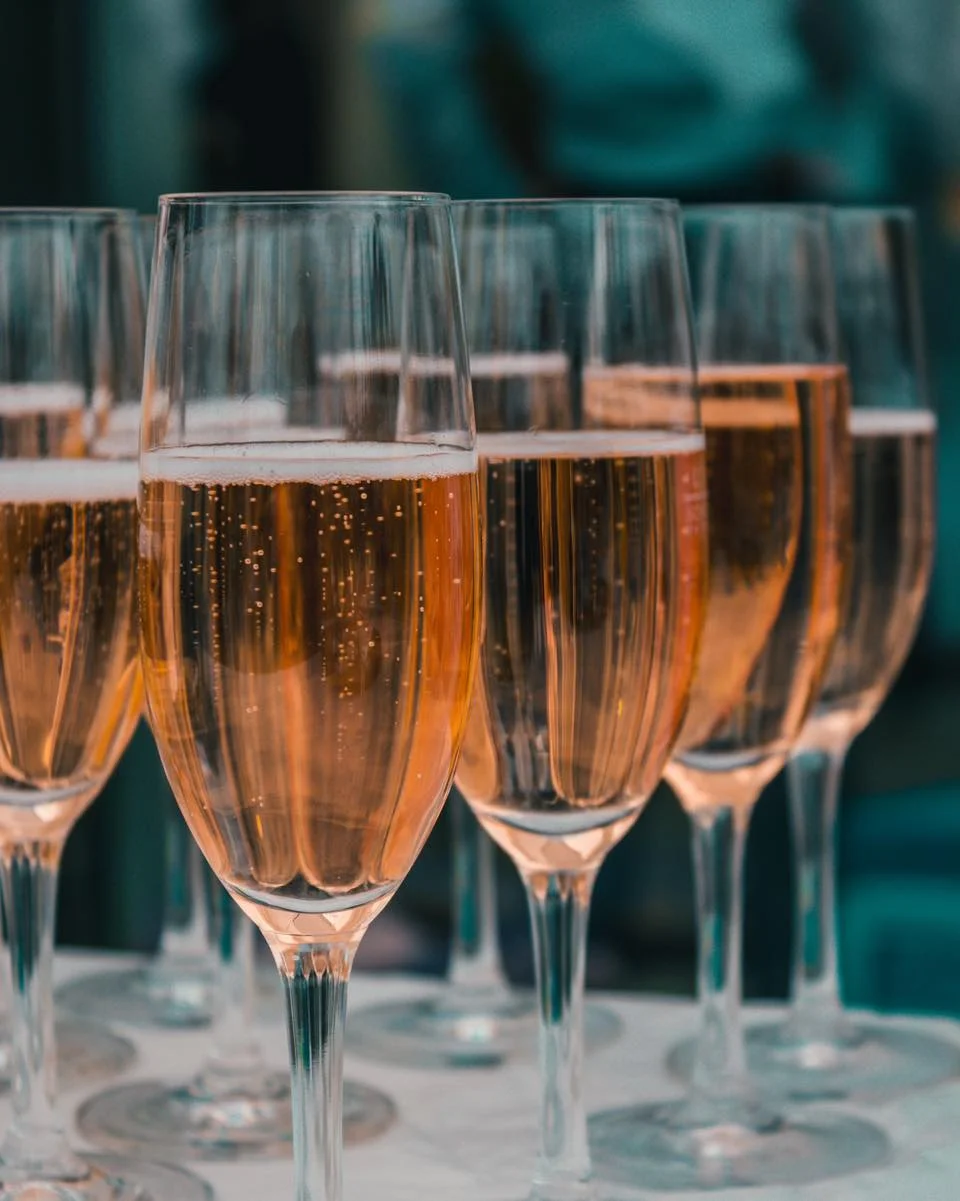 Elegant champagne flutes filled with sparkling rosé
