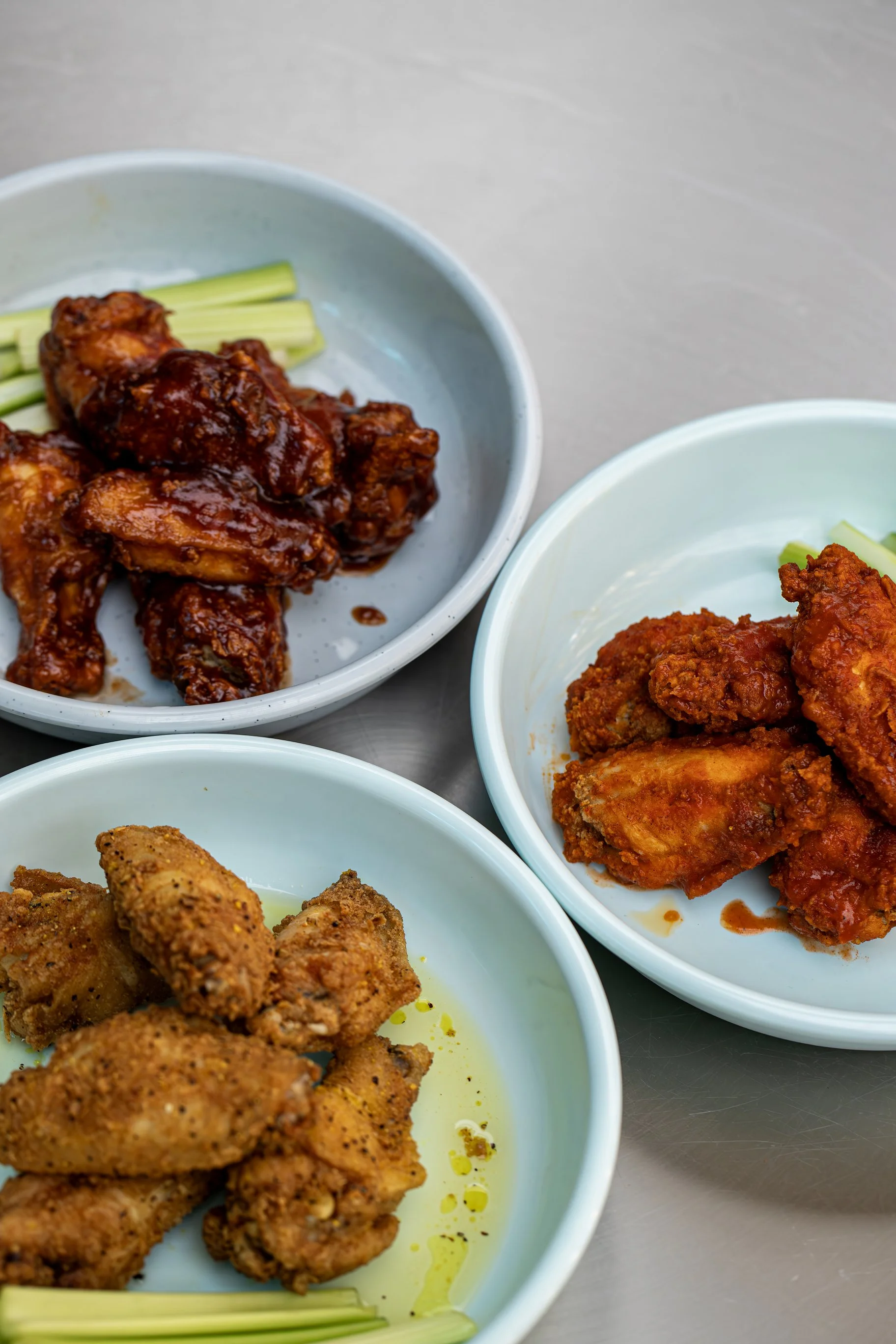 Assorted chicken wings with sauces in bowls