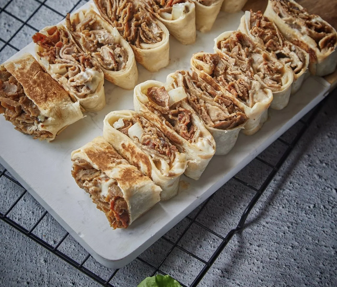 Delicious Turkish döner wrap slices on a serving board