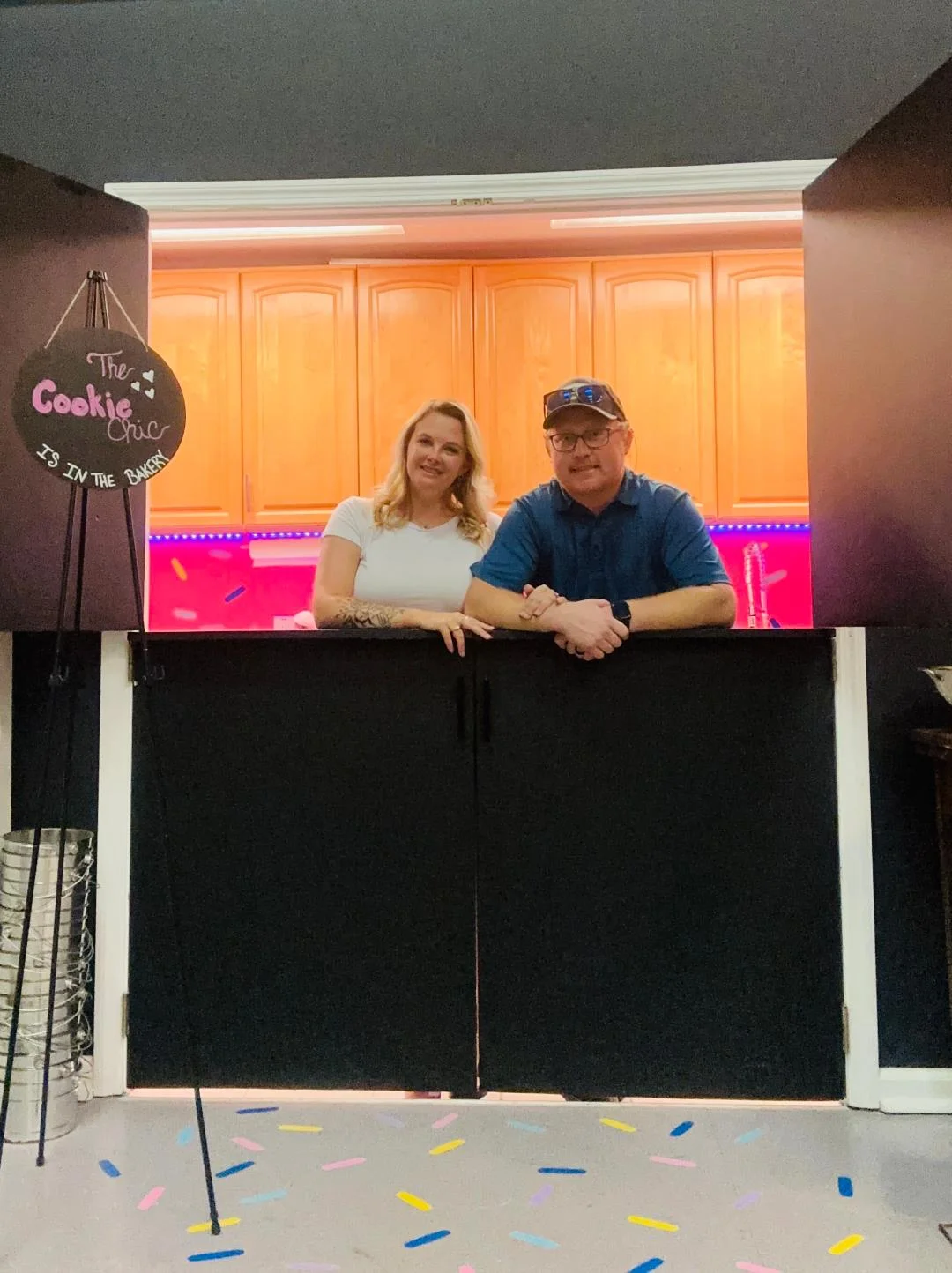 Bakery counter with cheerful owners at The Cookie Chic