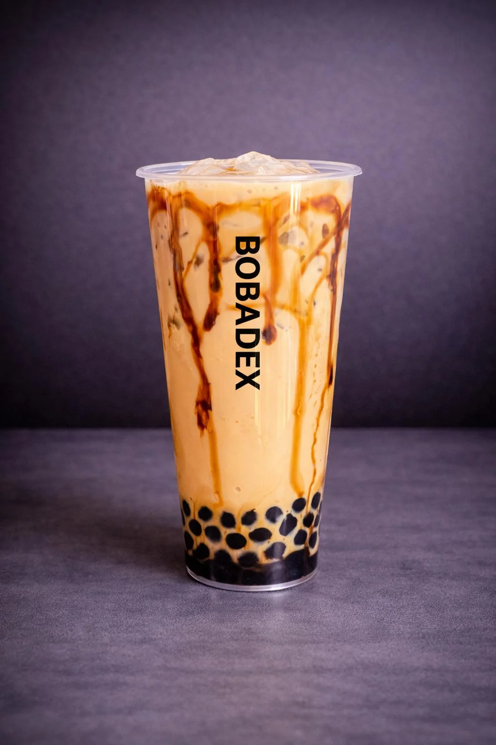 A glass of bubble tea with a layered appearance, showcasing a mix of brown and beige colors, placed next to cute plush figures.