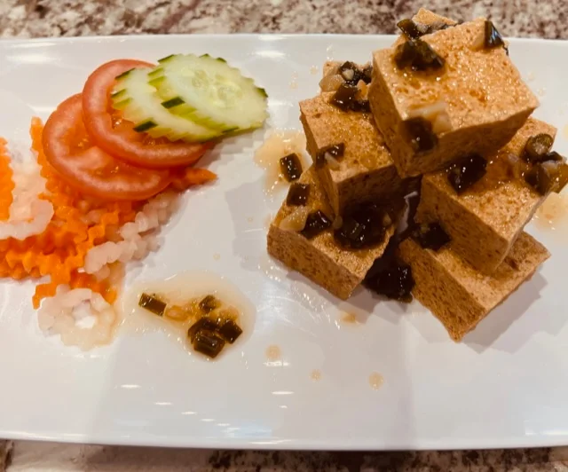 Japanese chilled tofu with garnishes and sauce