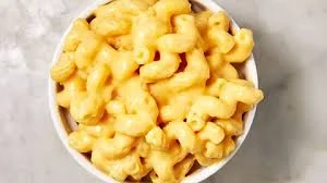 A bowl filled with creamy macaroni and cheese featuring elbow pasta coated in a rich cheese sauce.