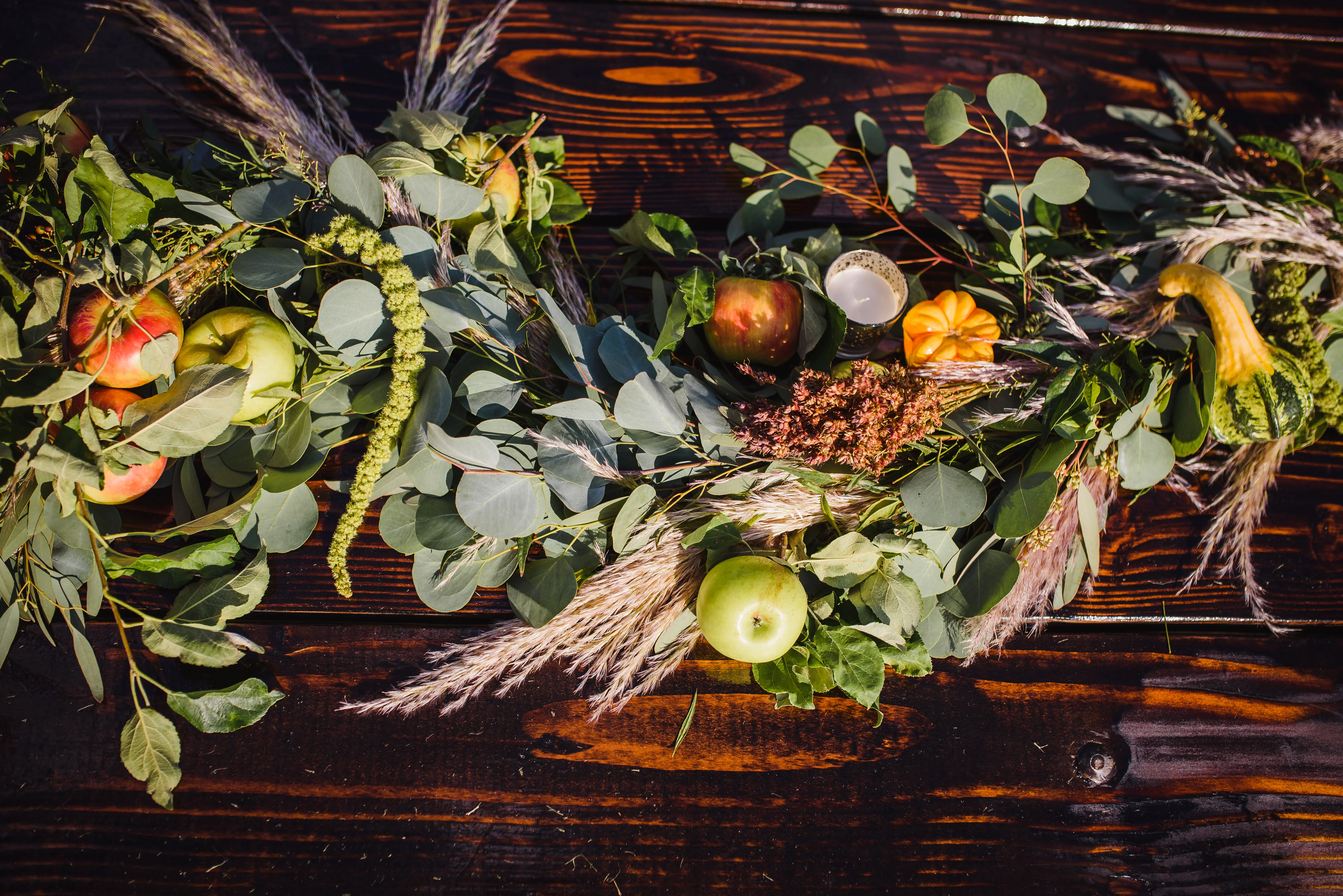 Autumnal floral arrangement with fruits and greenery