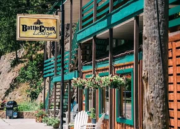 Exterior view of Battle Creek Lodge with sign and flower boxes.